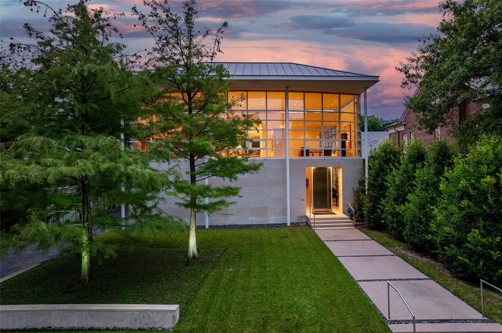 Experience the epitome of contemporary luxury in this breathtaking limestone-clad home, designed by renowned architect Lionel Morrison and built in 2001. This architectural masterpiece offers an exceptional blend of style, comfort, and functionality, located steps from Flippen Park. The first floor features a spacious entry with beautiful marble floors, elevator and stairwell access to the second floor, as well as generously sized secondary bedrooms, each with an en-suite bathroom. The second floor offers open-concept living spaces and dining with tall floor to ceiling windows and sweeping views of Flippen Park. The recently renovated sleek Bulthaup kitchen is equipped with Miele appliances, a dedicated wine refrigerator, and convenient access to a large outdoor kitchen and living area. An oversized primary suite with a spa-inspired en-suite bathroom and a study complete the second floor. The low maintenance backyard is lined in evergreen magnolias for privacy, has a tranquil water feature and gas fireplace — perfect for entertaining. A separate, additional 282 sq ft air conditioned flex space adjacent to the backyard is currently storage, but plumbed and ready to be converted into a guest suite, gym or studio. Additional highlights are pier and beam construction, a large 3-car garage with ample storage, and 3 new AC units for modern efficiency and comfort. This timeless home offers a unique opportunity to live in an architecturally significant home while enjoying the serenity and beauty of Flippen Park. Short walk to Highland Park Village, Bradfield Elementary, and Whole Foods. Schedule your private showing today!