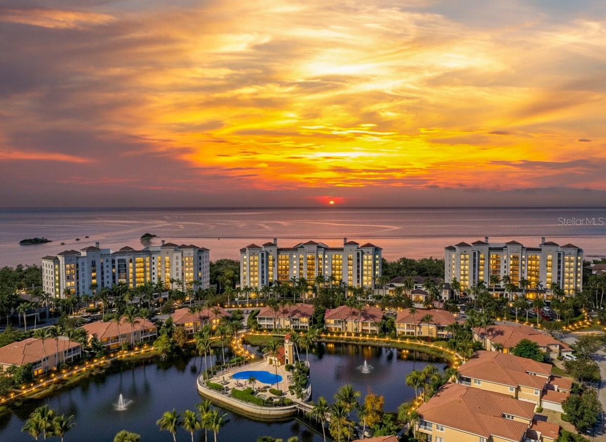 Waterfront Luxury Meets Boater’s Paradise at Burnt Store Marina. Experience an unparalleled coastal lifestyle from this incredible Grande Isle end-unit residence, perfectly perched on the desirable southern end of Tower Three. Optimally located on the fourth level, this sprawling, fully furnished home offers the perfect balance—elevated enough for sweeping views, yet deeply connected to the vibrant marine life and sparkling waters below. Nestled along the enchanting estuary of Charlotte Harbor, this is your gateway to one of Florida’s premier boating destinations. This light-filled sanctuary offers a pleasing open floor plan that has been freshly painted in a neutral palette, that provides a sophisticated backdrop ready for your personal touch. The sun-drenched living space is wrapped in abundant impact glass windows and sliding doors which flood this residence with natural light and are beautifully framed with premium plantation shutters and Hunter Douglas window treatments. The open culinary kitchen features handsome granite countertops, extensive cabinetry, and an expansive breakfast bar. Steps away, a stylish wet bar stands ready for mixing cocktails and hosting guests. Step outside to your private lanai to savor breathtaking sunsets and watch sailboats gracefully navigate the harbor and marina. The thoughtful layout features three generously sized bedrooms plus a versatile den behind elegant French doors—perfect for a home office, library, or media room. The primary suite is a true luxury retreat boasting a generously sized bedroom with soothing water and vegetation views and direct access to the lanai, a spacious walk in closet and a desirable en-suite bath with dual sinks, a deep soaking tub, and separate walk-in shower. The guest wing offers a spacious media room, two pleasing guest rooms, one with ensuite bath and walk in closet, and another full bathroom accessible to the main space as well.  Live like you are on a permanent vacation. Grande Isle residents enjoy exclusive access to world-class amenities:* Waterfront, Olympic-sized geothermal swimming pool and spa * Private fitness center, steam room, sauna, and grilling area * Grand salon and a private movie theater room. Beyond your front door lies the largest deep-water marina in Southwest Florida, offering unparalleled boating and fishing. The golf cart-friendly community boasts a 27-hole golf course, two on-site restaurants, an active social club, tennis, pickleball, and a fitness center. Offered fully furnished for an effortless transition into the Florida dream—just bring your toothbrush and your boat.