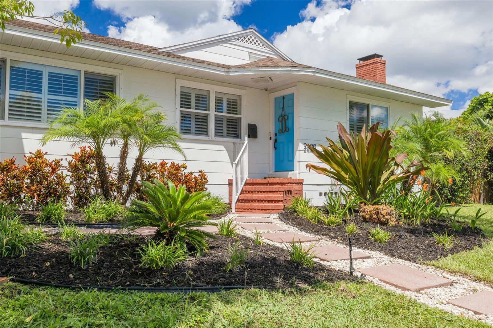 NEW PRICE! Discover your sanctuary, situated in HISTORIC KENWOOD, home of the famous porch parties, beautiful bungalows and winner of Neighborhoods USA, Neighborhood of the Year! This charming 4-bedroom, 2-bathroom residence offers a perfect blend of modern elegance and functionality, all while sitting proudly on a HIGH & DRY CORNER LOT IN AN X FLOOD ZONE. As you step inside, you're greeted by beautiful hardwood floors and plantation shutters that complement the home's warm and inviting atmosphere. The spacious living room features a cozy wood-burning fireplace, and opens to a versatile flex space through elegant French doors, ideal for an office or creative studio. The well-appointed kitchen boasts stainless steel appliances, leading to what could be a family room or more space that's perfect for hosting gatherings!The private primary suite, tucked away upstairs, offers a serene retreat and tranquil escape. Enjoy two separate closets! Outside, the tropical oasis continues with a heated, saltwater pool and an expansive, fenced side yard buffered from noise for ultimate privacy. Relax poolside under an umbrella and towering palm trees. Enjoy al fresco dining on the covered, screened porch, complete with a TV and an outdoor shower for post-pool refreshment. Additional features include a 2-car attached garage and CUSTOM HURRICANE SHUTTERS. This property provides easy access to St. Pete's vibrant Central Avenue with its array of restaurants, galleries, and shops. Plus, you being minutes away from the nearby interstate ensures smooth travel to the airport. This home is your perfect blend of elegance, privacy, and convenience!