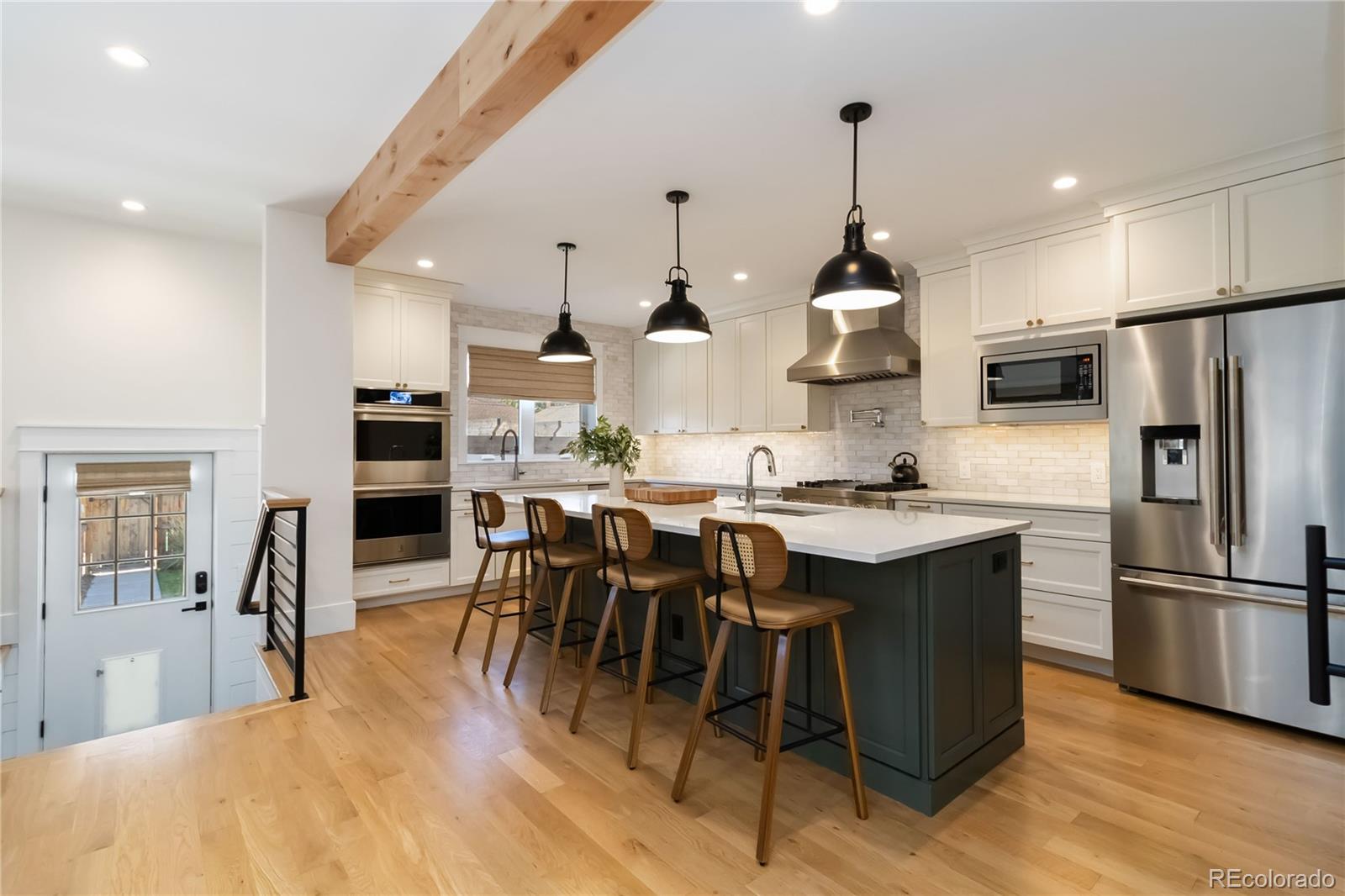 Stunning Park Hill Rebuild — Modern Luxury Infused With Historic Character  Prepare to be impressed by this exceptional 6-bedroom, 4-bath Park Hill residence—a true 2023 re-imagining rebuilt from the studs up, complete with a brand-new second story. Not a flip, this home was meticulously reconstructed to modern code with full permits; only the four original 1927 main-level exterior walls remain. The reclaimed brick façade preserves the home’s historic charm while seamlessly integrating with the newly built detached garage for a cohesive, timeless look.Step inside to an inviting open-concept main floor, where the dining area, living room, and chef’s kitchen flow effortlessly together. High-end appliances, custom finishes, and thoughtful design make this space ideal for both everyday living and entertaining. A built-in central vacuum system adds convenience throughout the home.The upper level features three generous bedrooms and a well-placed laundry room. The west-facing primary suite is a true retreat, offering dual walk-in closets and a spa-inspired five-piece bath complete with dual vanities, a makeup station, soaking tub, and steam shower.The fully finished basement expands your living options with two additional bedrooms (one non-conforming), a full bath, wet bar, and a spacious family or entertainment area—perfect for guests, hobbies, or movie nights.Outside, the professionally landscaped, fully fenced backyard provides a private oasis for relaxing, playing, or hosting gatherings. The oversized two-car garage—a rare Park Hill luxury—offers alley access and ample room for two full-size SUVs, including a Ram 1500.Every detail of this home has been intentionally crafted to deliver comfort, function, and sophistication. With premium finishes, high-end systems, and exceptional design throughout, this residence truly lives like a dream. Located just one block from Fairfax Commons, come experience it for yourself.