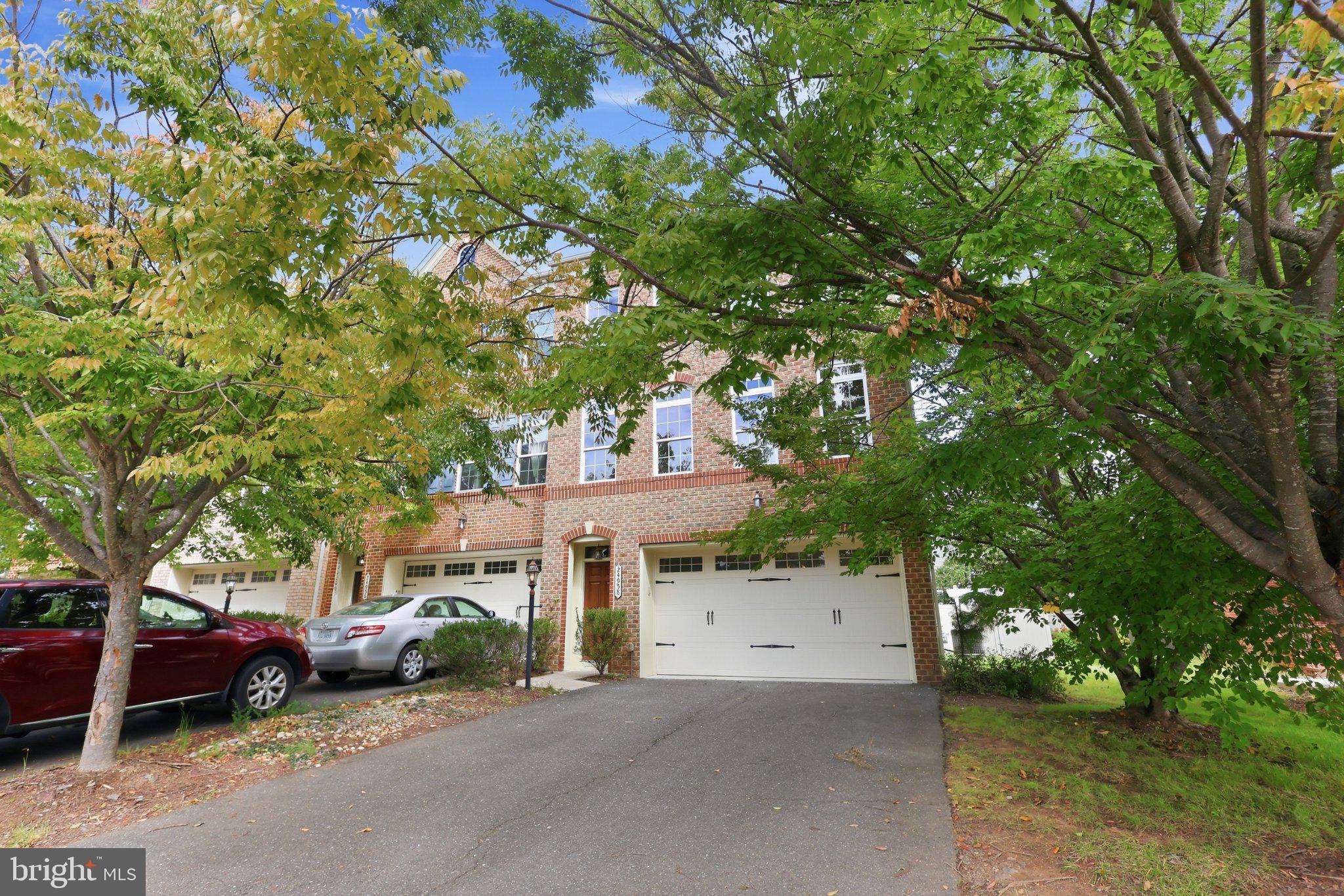 Welcome to this spacious end-unit townhome in the sought-after Avonlea community! This beautifully maintained home offers 3 bedrooms, 2.5 bathrooms, a 2-car garage and approximately 3,200 square feet of living space. Fresh paint and new carpet throughout give the home a clean, updated feel and make it truly move-in ready for the next owner.  The main level features hardwood floors and a bright, open layout with spacious living and dining areas, a comfortable family room and an open kitchen featuring granite countertops, stainless steel appliances, abundant cabinetry and a breakfast bar. Upstairs, the large primary suite includes a private bathroom and two walk-in closets. Two additional bedrooms, a full hall bathroom and conveniently located laundry complete the bedroom level. The lower level provides a large recreation room with plenty of flexibility for a second family room, home office, gym or playroom, with direct access to the fully fenced rear yard and a rough in for additional bathroom.  Enjoy everything Avonlea has to offer with walking trails, green space, a community pond, playgrounds and recreational amenities including tennis, pickleball and basketball courts. The community pool and trails are just a short walk from the home, while nearby South Riding offers plenty of shopping, dining and everyday conveniences. Convenient access to major commuter routes and Dulles International Airport completes this great home!