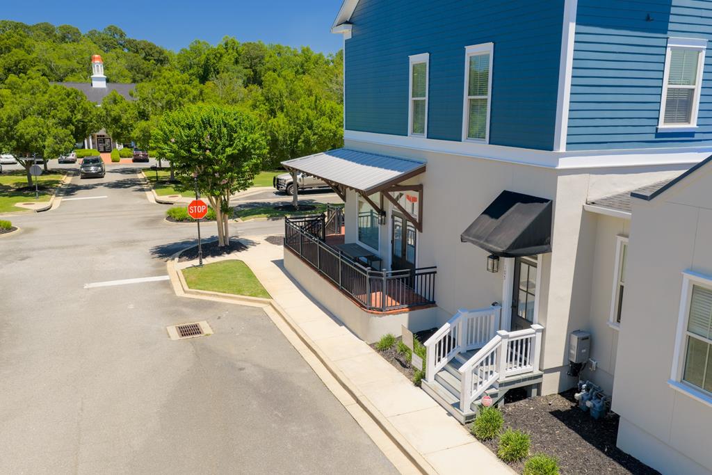Experience low-maintenance living in the highly desirable Madison Grove community with this charming 2-bedroom, 2.5-bath condominium offering over 1,400 square feet of thoughtfully designed living space. Located above the storefronts, this unique residence combines convenience, style, and comfort in one exceptional package.  The open-concept floor plan features soaring ceilings, a cozy fireplace, and an abundance of natural light streaming through large front-facing windows. The spacious main level includes the primary suite, a convenient laundry area, and a half bath for guests, creating easy everyday living.  Upstairs, you'll find a private second ensuite bedroom along with a versatile office or flex space—perfect for working from home, hobbies, or accommodating guests.  Ideally situated just steps from Madison Grove's clubhouse, swimming pool, and fitness center, residents enjoy resort-style amenities right outside their door. The unit also includes one dedicated parking space conveniently located at the entrance, with additional overflow parking available along the street and at the clubhouse parking lot.  Whether you're seeking a primary residence, lock-and-leave lifestyle, or investment opportunity, this beautifully maintained condo offers the perfect blend of comfort, convenience, and community living.