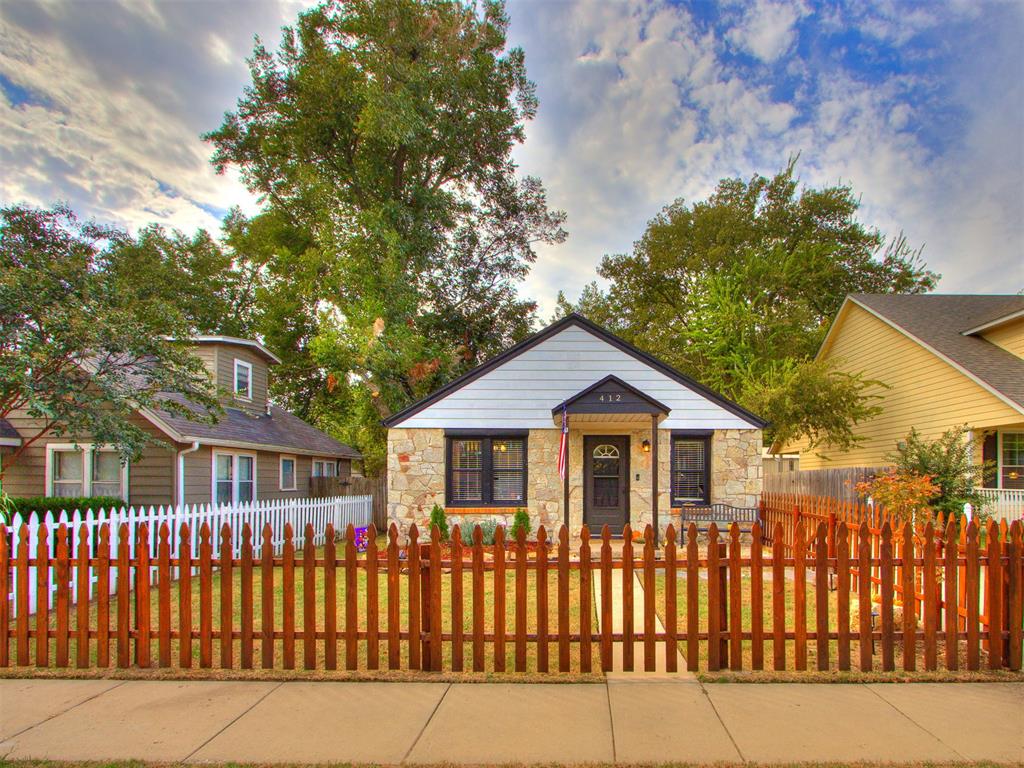 Step into the charm of an era that crafts this beautifully preserved home, blending timeless character with modern comfort. Inside, you’ll find two inviting bedrooms, a thoughtfully updated bathroom, and a refreshed kitchen featuring newer cabinetry and a full sink — the perfect foundation to add your personal touch. Natural light fills the home, creating a warm and welcoming atmosphere throughout. A nearly new roof, replaced just a year ago, offers peace of mind for years to come. The detached two-car garage provides generous storage and includes plumbing and a half bath, ideal for a workshop, hobby space, or future guest suite. The lot extends from the street to the alley, offering mature trees, a covered back deck, and plenty of room to relax or entertain outdoors. Perfectly located in central Norman, this home offers easy access to everything the city is known for. You’re just minutes from Main Street’s local shops and dining, Campus Corner’s vibrant restaurants and nightlife, and the University of Oklahoma campus. Shopping and conveniences like Sooner Mall and the University Town Center retail district are also close at hand, keeping everything you need within easy reach.
This property is a rare find — combining historical charm, and a location that places you near the best of Norman. Whether you’re a first-time buyer, investor, or just looking to move, this home offers endless potential to create something truly special.