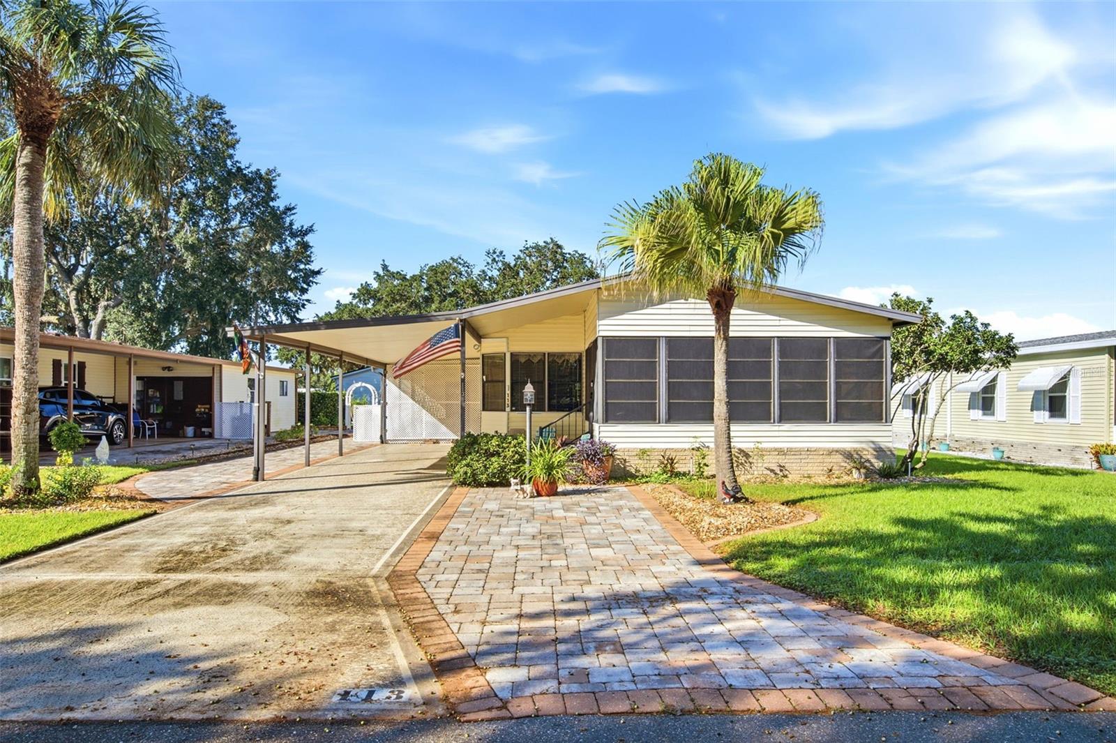 Virtually Staged. Welcome to 113 Jackson Park Avenue, located in the desirable 55+ Polo Park golf community! This beautifully maintained 2-bedroom, 2-bathroom home offers an inviting open floor plan, thoughtful updates, and an abundance of living space. Step into the spacious Florida room, filled with natural light, before entering the main living area, where the open-concept kitchen, dining, and living spaces flow seamlessly together. The kitchen serves as the heart of the home, featuring updated appliances, a large center island with seating, and ample cabinetry for storage. New tile flooring extends throughout the home, providing a fresh, cohesive look. The spacious primary suite features French doors leading to the en-suite bathroom, complete with an updated shower and countertops. The secondary bathroom also features updated countertops. Additional highlights include convenient interior laundry, a generous storage room, a double carport, and an additional paver parking pad. Beautiful landscaping enhances the home's curb appeal and creates a welcoming first impression. With its spacious layout, modern updates, and inviting indoor and outdoor spaces, this home is ready for its next owner. Schedule your private showing today!
