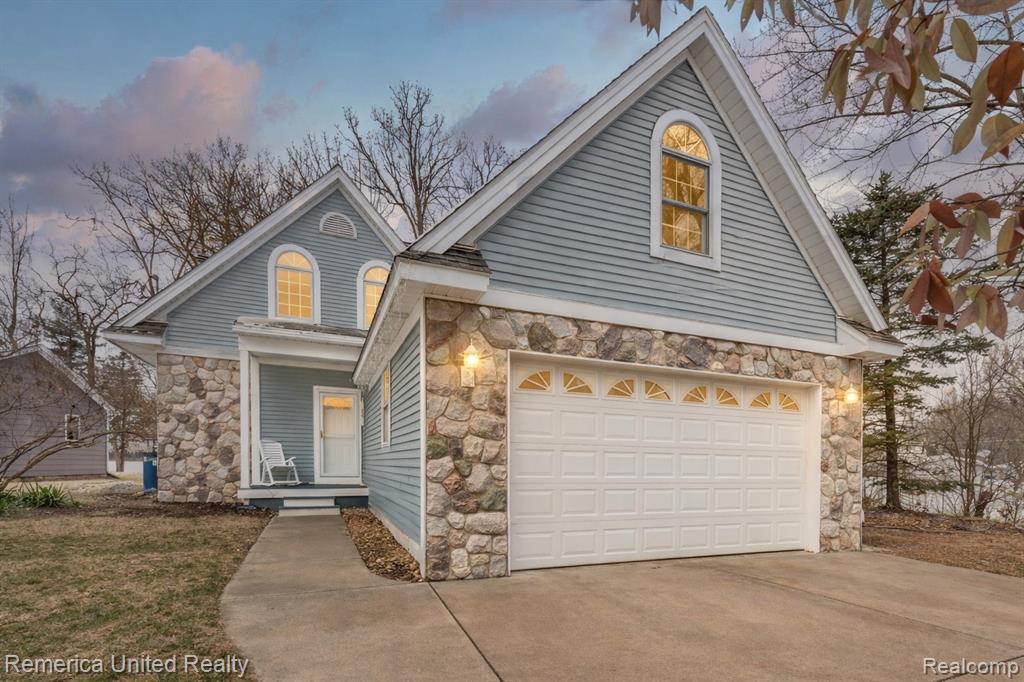 Experience lakefront living at it’s finest on all-sports Round Lake in Hartland. Set on a gorgeous lot with pristine, panoramic water views, this 3-bedroom, 2.5-bath home offers the lifestyle of an Up North retreat—without the drive!  This home has been updated throughout the years and features new luxury vinyl plank flooring throughout, ideal for waterfront living, a thoughtfully designed floor plan and plenty of storage. The kitchen offers abundant cabinet space, brand new dishwasher and range and a walk-in pantry, perfect for entertaining and everyday use. The living room is highlighted by a cozy stone fireplace and expansive windows that frame stunning lake views.  Main-level living is enhanced by a spacious first-floor bedroom with breathtaking views of Round Lake, a full bath, and convenient first-floor laundry. Upstairs, you’ll find two oversized bedrooms with vaulted ceilings and large windows that flood the space with natural light, along with a Jack-and-Jill full bath and an additional half bath.  Outdoors, enjoy a shallow sandy beach, included dock, and endless opportunities for boating, swimming, and relaxation. A storage shed provides space for lake toys, while the 2-car attached garage includes an unfinished bonus room above—ideal for extra storage or easily finished for additional living space.  Vacation at home year-round while enjoying the convenience of nearby shopping, dining, and easy access to expressways. Property across the lake is in a nature conservancy. **Sellers are motivated and will consider all offers!