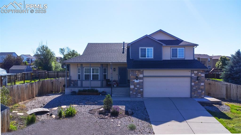 This charming 3-bedroom, 2.5-bathroom home offers breathtaking, unobstructed views of Pikes Peak right from the front porch. Inside, enjoy a cozy living room with an electric fireplace and a kitchen featuring brand-new quartz countertops, a spacious single-basin sink, and sleek stainless steel appliances. The lower level boasts a custom bar area, perfect for entertaining, while the sizable laundry room adds convenience to daily chores. The unfinished basement includes a bathroom that's already roughed in with a sink, toilet, and bathtub—just awaiting your finishing touches to complete the space. Outside, the fenced-in backyard includes a deck with a hot tub, designated RV parking, areas for raised garden beds, and a chicken run, catering to sustainable living enthusiasts.