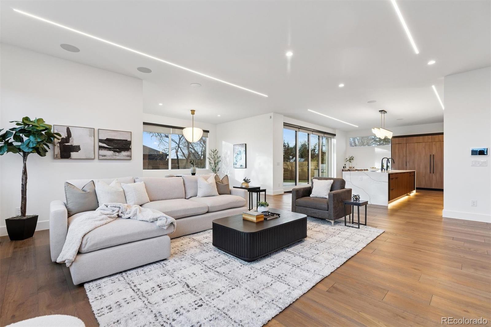 Introducing this exquisite custom Hill Top residence, boasting a three-car garage, five bedrooms, seven bathrooms, and 8,247 sq. ft. of meticulously designed living space. As you enter through the stately foyer, soaring vaulted ceilings create an immediate sense of grandeur. The open-concept main level flows effortlessly from a formal dining area with a double-sided fireplace warming both the dining room and adjacent family room to a breathtaking gourmet kitchen that’s a true chef’s dream, featuring premium Thermador and Wolf appliances, including a spacious Thermador refrigerator, a high-performance Wolf gas range, and two Wolf wall ovens for ultimate versatility. A generous island offers casual dining, while an attached second kitchen provides additional convenience with a full-size refrigerator, dishwasher, sink, and ample counter space—ideal for entertaining or managing a busy household. The expansive primary suite is a luxurious retreat with magnificent mountain views, a cozy fireplace, and a dry bar, while the spa-like primary bath includes his-and-her walk-in closets, separate water closets, dual vanities, a double shower with steam, a soaking tub, heated floors, and a heated towel rack. Laundry is exceptionally convenient with three full washer/dryer sets: two in the second-floor laundry room and one on the main level. Additional highlights include a versatile third-level bonus room (currently a workout area) with a fireplace and west-facing viewing deck offering stunning sunsets, plus a state-of-the-art basement entertainment wing featuring a tiered movie theater with a 4K audio-visual system, custom wet bar kitchen, expansive family room, climate-controlled wine room, and a guest bedroom, all accessed by an elevator serving all levels for effortless living. Every detail in this thoughtfully designed home has been crafted for maximum comfort, luxury, and effortless living.