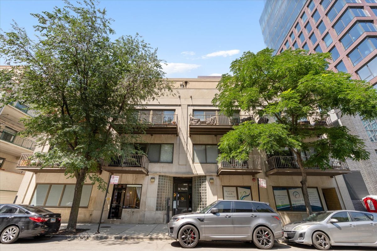 Located steps from the West Loop's Restaurant Row, this rare, turnkey 2bd/2ba end-unit loft blends authentic Chicago character with high-end updates throughout. Soaring 11-foot timber ceilings, exposed brick, and oversized windows fill the home with natural light, creating a warm and inviting atmosphere. The open floor plan seamlessly combines the kitchen and family room, creating a space designed for both everyday living and entertaining. The fully renovated kitchen is a centerpiece of style and function, featuring quartz countertops, stainless steel appliances, and a generous island perfect for gatherings. The family room, anchored by a cozy gas fireplace, opens to walls of oversized windows leading to an east-facing 17-foot balcony with serene treetop views.  The primary suite offers a true retreat with a spacious walk-in closet with custom organizers and a spa-inspired bathroom with a dual vanity, soaking tub, and separate walk-in shower. The second bedroom is ideal for a guest room or home office and features custom closets for ample storage. Prime deeded garage parking ($30,000) and dedicated storage add convenience. This premier location offers it all. Just steps from Randolph Street and moments from Fulton Market, you are surrounded by some of Chicago's most celebrated dining, boutiques, parks, and enjoy seamless access to transit and the expressway. For those seeking loft living with architectural character and beautifully elevated interiors in the heart of the West Loop, this home delivers a rare combination of authenticity, comfort, and quiet luxury the moment you walk through the door, the perfect balance of vibrant city energy and everyday ease.