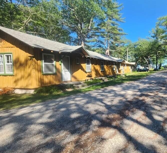 Potential buyer's dream. Your chance to get 3 complete units with 1 purchase. Older cabins with few updates that include new windows installed summer 2024, new flooring and paint in 2021, and new washer and dryer in 2023. Each unit comes with its own full bathroom, kitchen, living and sleeping area. Association fees are $125 per month. Includes beach access to Lake Huron.BATVAI