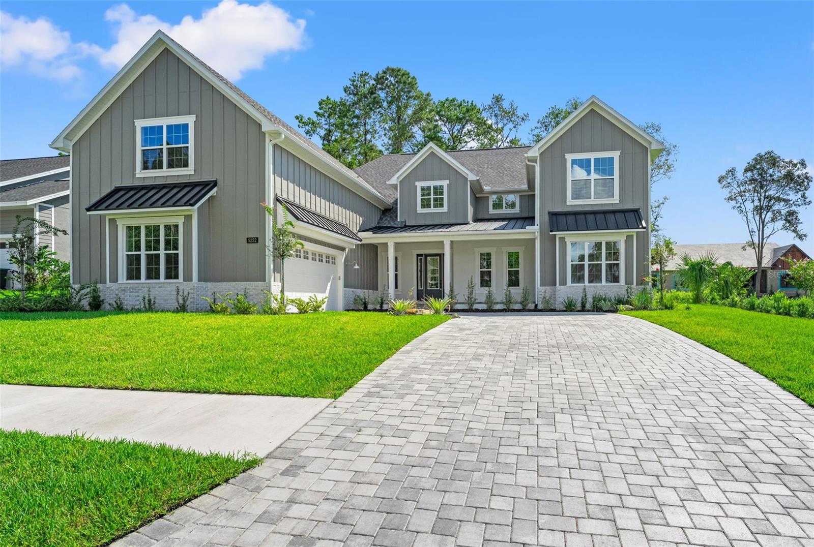 Experience unparalleled elegance in this custom-built, one-of-a-kind 5-bedroom, 3-bathroom luxury home nestled within the prestigious Southern Hills Plantation Club, set along the iconic Pete Dye-designed 18-hole golf course. This stunning 2-story residence welcomes you with soaring 22' ceilings, custom beams, and expansive second-story windows that flood the space with natural light, highlighting an exquisite living room adorned with a striking porcelain and oak paneling feature wall. The gourmet kitchen is a chef's dream, featuring a sleek porcelain island, sophisticated under- and above-cabinet lighting, a top-of-the-line Z-Line appliance package, a gas cooktop and oven, and an additional wall oven. Above the spacious 2-car garage, a versatile converted loft space offers endless possibilities—perfect as a theater room, game room, wellness retreat, or anything you can imagine! Outside, beautifully paved front and back patios provide serene spots to relax, with views of a neighbor-owned lot, which has been created into a botanical garden next door and an undeveloped lot across the street, ensuring exceptional privacy and tranquility. Residents enjoy exclusive access to Southern Hills' resort-style amenities, including a par-3 walking course, putting greens, pro shop, clubhouse, pool, spa, poolside dining, gym, pickleball, and Har-Tru tennis courts—all just under an hour from Tampa. This architectural gem seamlessly blends modern sophistication with timeless luxury. Call today to schedule a private tour of this extraordinary home!