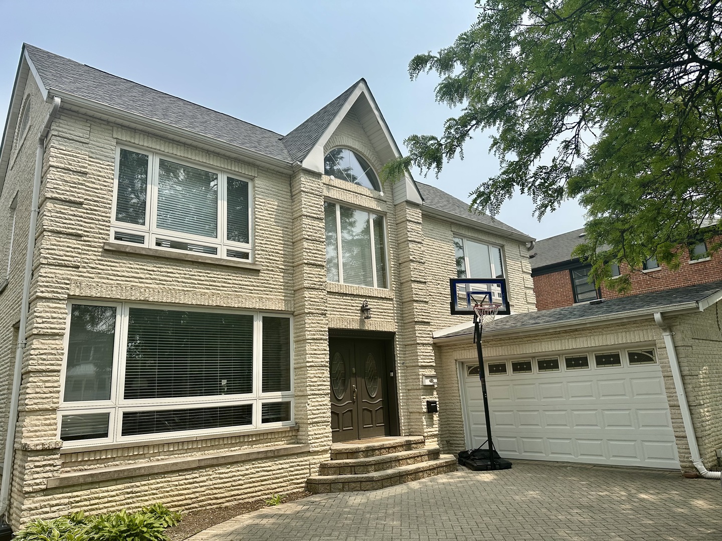 Live Large in Budlong Woods! Step into this elegant urban oasis where spacious design meets timeless charm. Nestled on a generous 60x133 lot, this 5-bedroom, 4.1-bath stunner delivers everything today's discerning buyer dreams of-space, style, and serenity.    On the main floor, a dramatic two-story foyer welcomes you to a layout crafted for effortless entertaining. Picture cozy evenings by the fireplace in the formal living room, memorable holidays in the formal dining room, and casual mornings in a spectacular chef's kitchen that blends beauty with functionality. Just beyond, the family room glows with sunlight, thanks to oversized windows and direct access to a landscaped patio perfect for summer soirees.  If you work from home, we have something for you too.  A first floor office full of natural light where you can thrive and grow your business.  Upstairs, retreat to your tranquil primary suite-featuring a private terrace with views of your own park-like backyard. Three additional bedrooms offer comfort and flexibility for guests and growing families.  Downstairs, the finished basement delivers even more livable space, including a rec room with fireplace, a playroom, a full bath, an oversized laundry room, and plentiful storage.  This beautifully maintained home features dual-zone HVAC, a brand new roof, and thoughtful updates over the past decade. All of this just minutes from Northside College Prep, Lincoln Square's shops, cafes, and the North Branch Trail for weekend adventures.