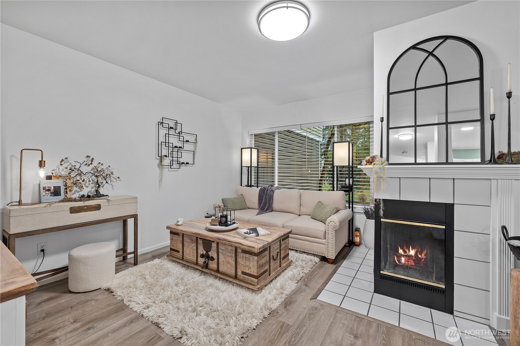 Excellent investment opportunity! No rental cap, and a model tenant. Updated and beautifully positioned along a tranquil greenbelt, this spacious one-bedroom, one-bath home offers serene Lake Sammamish views. Thoughtful renovations shine throughout, including a contemporary kitchen with a welcoming breakfast bar, and A charming corner fireplace warms both the living and dining areas, where you can enjoy glimpses of the lake year-round. Step outside to the private patio, ideal for summer grilling, relaxing with pets, or simply unwinding in the peaceful setting. The generously sized bedroom and bath provide comfort and style, complemented by in-unit laundry, abundant storage, and easy access to I-90 and 405 for stress-free commuting.