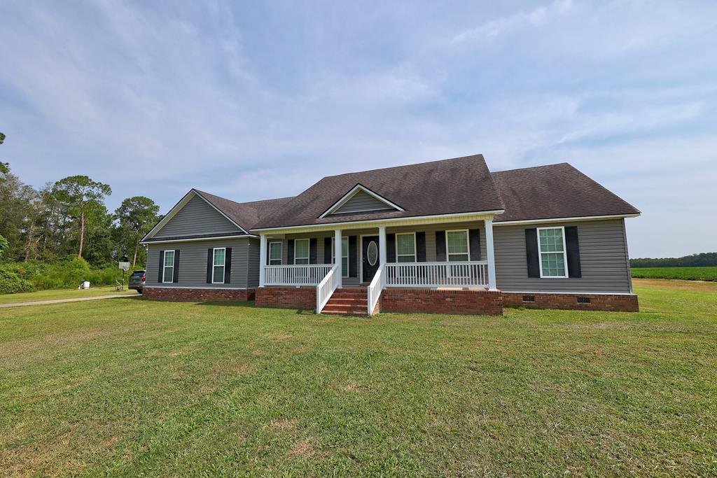 Escape to the quiet of the countryside with this beautiful 2.27-acre property nestled on a family farm, where wide-open fields and peaceful surroundings offer the best of rural living. The scenic views and neighboring farmland create a sense of space that extends far beyond the property lines, making this a place you'll love coming home to.  Inside, this well-designed 4-bedroom, 2-bath home features a split-bedroom floor plan that offers privacy for the primary suite while keeping the main living areas open and inviting. The spacious great room serves as the heart of the home, flowing effortlessly into the kitchen, breakfast area, and living room—ideal for gathering with family and friends. A secure safe room provides the perfect place to store firearms, valuables, important documents, or other treasured belongings.  Built with country living in mind, the impressive 48' x 36' metal shop is ready for work or play. Featuring four roll-up bay doors, there's plenty of room for tractors, ATVs, equipment, boats, or workshop space. The shop is also wired with a generator hookup to supply power to the home during outages (generator not included) and includes a convenient RV/travel trailer hookup along the side.  Whether you're looking for a place to enjoy a slower pace of life, work on projects, or simply appreciate the beauty of the countryside, this property offers the perfect combination of comfort, functionality, and rural charm. And when it comes to country living, good neighbors are worth their weight in gold.
