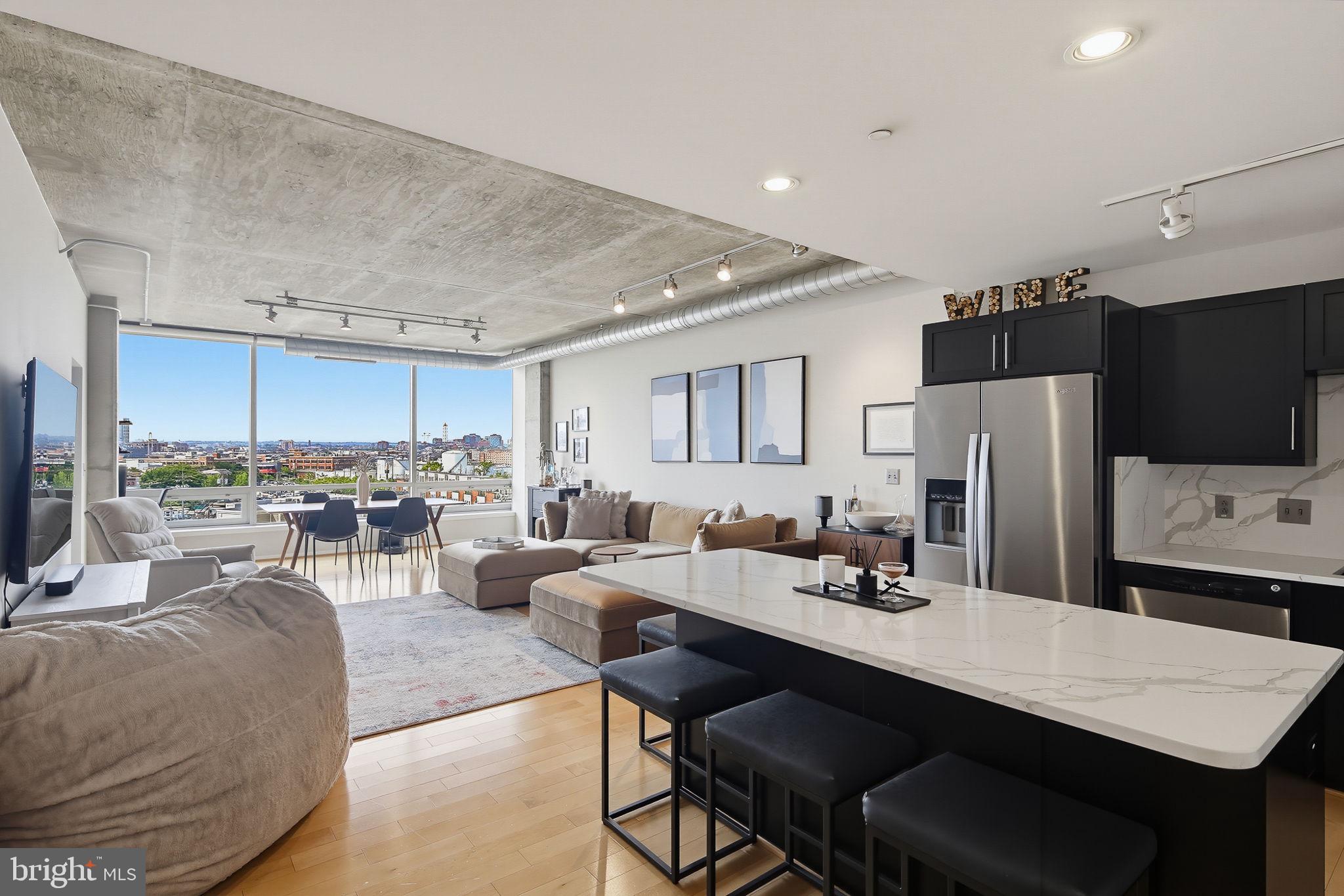 Experience sophisticated city living at Silo Point, Baltimore's iconic luxury waterfront condominium in the heart of Locust Point. This beautifully appointed one-bedroom, one-and-a-half-bath residence offers the perfect blend of contemporary style, open-concept living, and stunning panoramic views of the Baltimore skyline. Thoughtfully designed to maximize both comfort and functionality, the home features soaring ceilings, expansive windows, and an abundance of natural light that fills the spacious living area. The open-concept floor plan seamlessly connects the living, dining, and kitchen spaces, creating an inviting setting for both everyday living and entertaining while showcasing impressive city skyline views. The well-appointed kitchen offers generous counter space, quality appliances, abundant cabinetry, and an efficient layout designed for both convenience and style. Flowing effortlessly into the main living area, it creates an ideal space for gathering with family and friends. The spacious primary suite provides a private retreat with ample closet space and a full en-suite bath, while a separate powder room offers added convenience for guests. Every detail has been thoughtfully designed to create a home that is as comfortable as it is elegant. A brand new washer and dryer complete the space. One of the home's standout features is its breathtaking city skyline views, providing a spectacular backdrop both day and night. Whether enjoying your morning coffee or unwinding after a busy day, the ever-changing cityscape creates an exceptional living experience. Residents of Silo Point enjoy an unmatched collection of luxury amenities, including 24-hour concierge service, professional on-site management, a state-of-the-art fitness center, the spectacular 19th-floor Sky Lounge with sweeping harbor and city views, conference and meeting rooms, a game room, library, Wi-Fi throughout the lobby and Sky Lounge, pet-friendly amenities, and TWO preferred assigned parking spaces ideally located adjacent to the stairwell doors for exceptional convenience. Located in the highly desirable Locust Point neighborhood, Silo Point is just moments from Fort McHenry National Monument, waterfront promenades, Tide Point, Baltimore Peninsula, Latrobe Park, acclaimed restaurants, local breweries, boutique shopping, and the Water Taxi. With convenient access to Downtown Baltimore, the Inner Harbor, and major commuter routes including I-95, I-295, I-395, I-695, and I-895, commuting throughout the region is effortless. Combining iconic industrial-inspired architecture, first-class amenities, breathtaking skyline views, and an unbeatable waterfront location, Condo #630 offers an exceptional opportunity to enjoy one of Baltimore's most sought-after luxury condominium lifestyles.