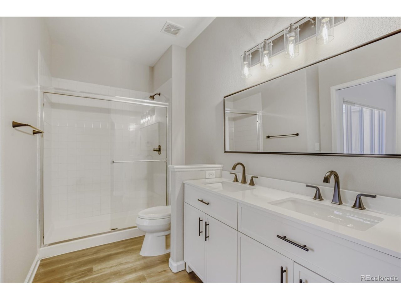 Discover the perfect blend of modern luxury and effortless main-floor living in the highly sought-after River West community of Windsor. This recently renovated ranch-style home greets you with a bright, open-concept floor plan anchored by a cozy living room featuring a classic gas fireplace. The heart of the home is the stunning, remodeled kitchen, boasting sleek quartz countertops, a breakfast bar for casual dining, and brand-new stainless steel appliances. Adjacent to the kitchen, the dining room serves as a true centerpiece, showcasing gorgeous vaulted ceilings and expansive windows that bathe the space in natural light. The main-level primary suite offers a private sanctuary complete with a generous en-suite bath and a large walk-in closet. The main floor also hosts a second comfortable bedroom, a full guest bath, and a dedicated laundry room with direct access to the attached two-car garage-perfectly designed for ease of use. Downstairs, the finished basement significantly expands your living space, featuring a massive family room, two additional well-sized bedrooms, another full bath, and a separate storage room. The outdoor space is just as inviting, with a fully fenced backyard, mature trees, and a sunny patio made for weekend BBQs. Practical upgrades like the south-facing driveway ensure snow melts quickly in the winter, while the recent high-end remodel means you can move in with total peace of mind. Situated just moments from numerous lakes, reservoirs, and the scenic Poudre River Trail, this home offers unparalleled access to outdoor recreation while keeping you close to the heart of Windsor.