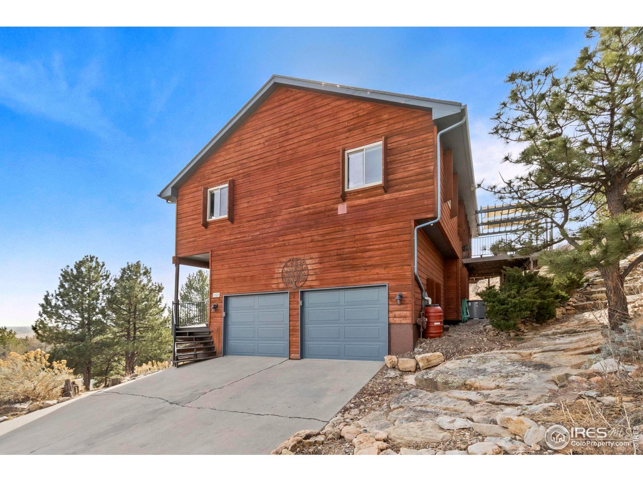 Foothills retreat with sweeping views and thoughtfully updated living spaces at 1601 Cliff Side Drive Loveland. Perfectly positioned among rock outcroppings and mature pines, this private mountain-inspired residence offers expansive decks for outdoor entertaining, quiet morning coffee, and spectacular Colorado sunrises. Inside, warm natural light fills an open, inviting layout. The updated kitchen offers generous prep space, quartz countertops, butcher block mobile island, custom cabinetry pull outs and all appliances included providing seamless flow to indoor-outdoor living areas, ideal for hosting or everyday comfort. Spacious bedrooms with carpet new in 2025 provide peaceful retreats, while flexible living areas support remote work, guests, or hobby space. Multiple tiered decks extend the home into nature-perfect for dining under the stars, wildlife watching, or simply enjoying the foothills serenity. Perennial garden beds have been planted around the decks. Recent improvements include Lennox heat pump with gas furnace back up, 10 kW solar system offsets electrical bills and EV plug in garage provides move-in-ready conveniences. Located just minutes to Loveland amenities, hiking trails, and an easy drive to Fort Collins, Estes Park, and Rocky Mountain National Park, this property offers the rare combination of privacy, views, and accessibility. Experience Colorado foothills living with space to relax, entertain, and recharge. Assumable loan with 4.25% interest rate available to qualifying buyers-inquire with Brokers for more information.