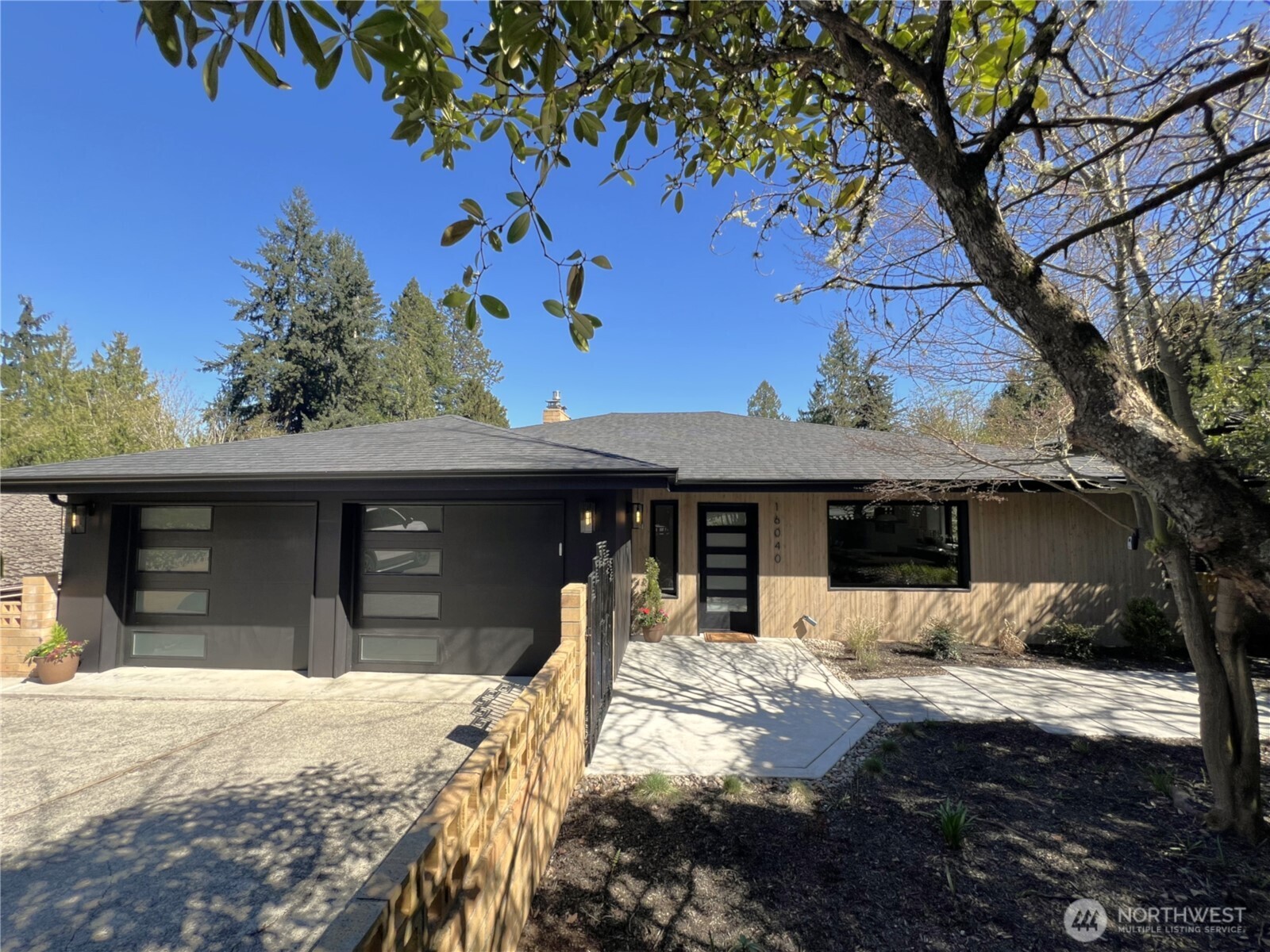 This beautifully updated home perched in Sheridan Heights area, offers spacious living with modern amenities and a partial view of Lake Washington and mountains. Designed for entertaining with generous gathering spaces and hardwood floors that flow seamlessly in this open concept floor plan. The gourmet kitchen that fits everyone features custom cabinetry, quartz countertops, new appliances, and an expansive island. This home boasts five spacious bedrooms and bathrooms. The primary suite impresses with a gas fireplace, access to deck, large walk in-closet, and ensuite bath with luxury finishes and a heated floor. Hang out on bottom level with a huge rec room and wet bar, 5th bedroom/office, bathroom, and a covered deck to gather on any season. Decks on every level with gas available are great spaces all year long and look over a large fully fenced backyard. Located near top-rated schools, Burk Gilman trail, town center, and Sheridan Beach club. This home is within the Sheridan Beach Club associate membership zone, on a quiet street, and truly stands out!