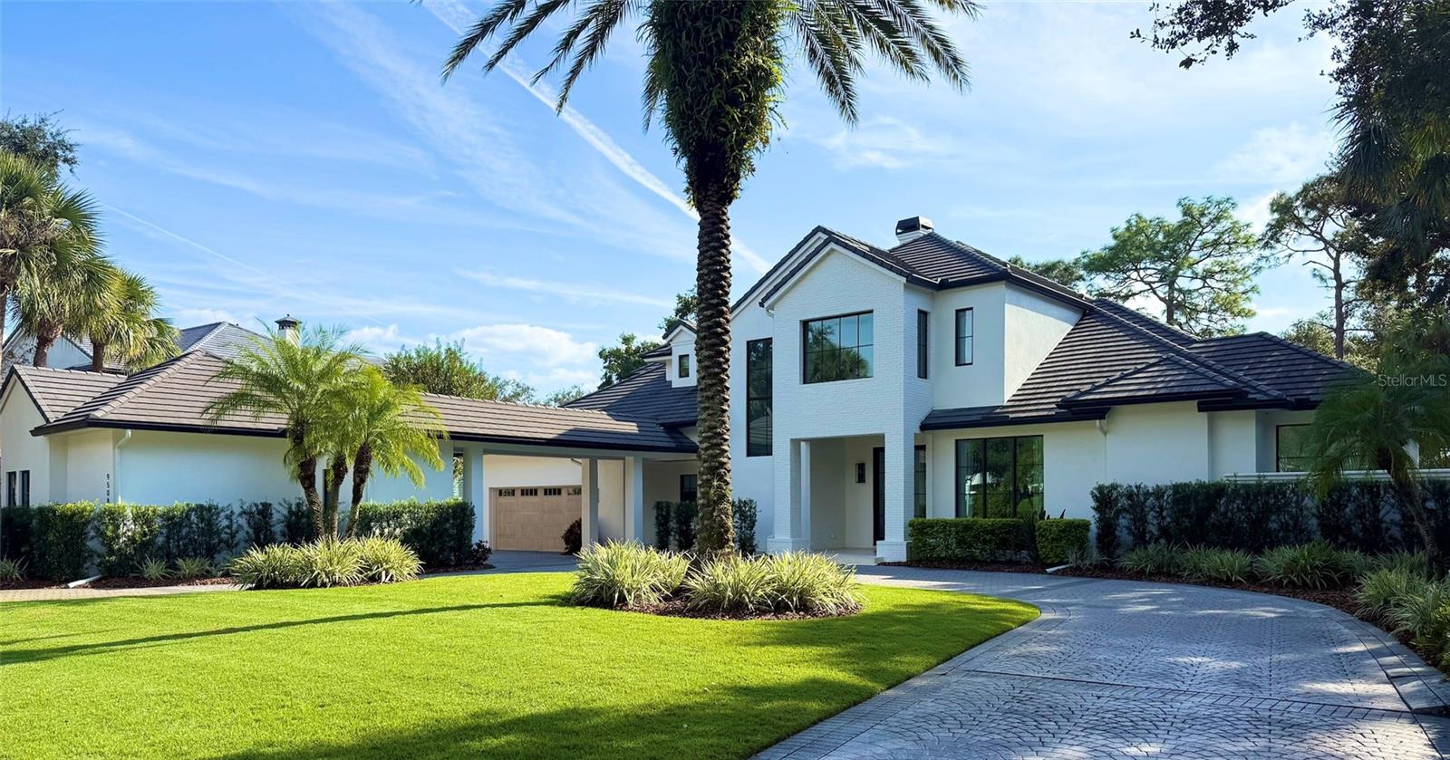 Under contract-accepting backup offers. Welcome to this stunning transitional residence located behind the gates of the renowned Lake Nona Golf & Country Club. Set on 0.54 acres and spanning nearly 6,100 sq. ft., this beautifully reimagined home offers breathtaking golf and pond views from the moment you arrive.Completely remodeled by DeVoe Custom Homes, every inch has been thoughtfully transformed, from the roof, windows, doors and everything on the interior. The heart of the home is the exceptional chef’s kitchen, featuring dual islands, custom cabinetry, top-of-the-line appliances, and unique stone countertops, complemented by an impressive oversized hidden pantry.The first floor offers an ideal layout with the primary suite, a dedicated office, living room, dining room, kitchen, family room, a secondary guest suite, and a beautifully designed laundry room. The dining and living rooms share a striking double-sided gas fireplace, with the dining room highlighted by a stunning wood-clad ceiling.Upstairs, a spacious loft with custom built-ins anchors three additional bedrooms, each with its own en-suite bath. A large screened balcony provides an elevated vantage point to enjoy serene views of the golf course and water.Outdoors, the gorgeous pool sits against the perfect backdrop of championship fairways and tranquil pond scenery. The expansive covered patio features a tongue-and-groove ceiling and a well-appointed summer kitchen, ideal for effortless entertaining.A four-car garage, circular driveway, and fresh professional landscaping complete the exceptional curb appeal.This home truly has it all, luxury, design, functionality, and one of the most desirable settings in Lake Nona.
