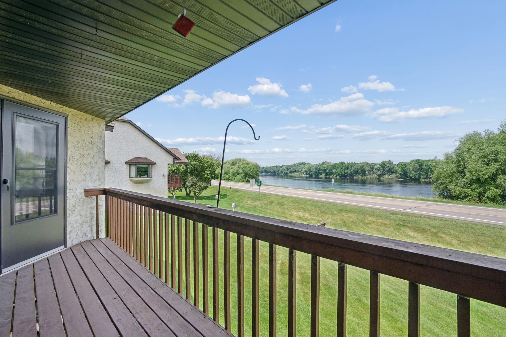 Beautiful one-level townhouse with an open floor plan and stunning views of the Mississippi River from the deck and backyard-facing windows. This thoughtfully renovated 2-bedroom, 3-bathroom home is designed for comfortable, accessible one-level living and features custom modern stair railings, updated bathrooms, and a remodeled kitchen with granite countertops, tile backsplash, updated door hardware, lighting, and appliances. Grab bars have been installed in all bathrooms for added safety. Wake up to beautiful river views from the spacious primary suite, which includes a private full bathroom, walk-in closet, and direct access to the deck. A second bedroom, convenient half bath, and laundry room are also located on the main level. The beautifully finished lower level offers a large family room with built-in cabinetry for storage, a cozy gas fireplace, a full bathroom with a jetted tub, a dedicated office, ample storage space, and a glass door leading to a private patio. The attached two-car garage is fully finished. Newer roof 2004. Conveniently located less than a mile from shopping, grocery stores, restaurants, and with easy access to I-94, this exceptional home combines breathtaking river views, modern updates, and everyday convenience.