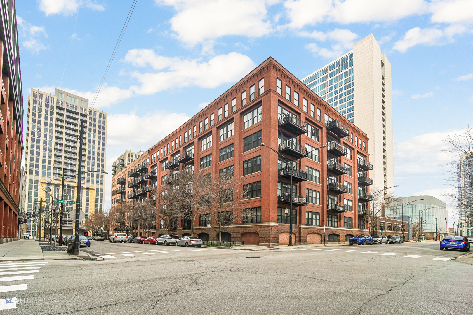 River North, over-sized brick & timber 1 bed / 1 bath loft with secured parking included. Not a cookie cutter condo. Sunlight beams through entire unit from its oversized windows. Open concept floorplan with plenty of space for dining table and kitchen w/ample cabinetry & stainless appliances. This unit features the rare to find fully enclosed, private bedroom with a huge windows! The bedroom has a custom "shiplap" wood accent wall with sconces, 2 closets, and an attached bathroom. Bath features double sinks, tub/shower and is also accessible from hallway, perfect for guests. Cozy up to the fireplace during cold weather months or enjoy cocktails/grilling from balcony in spring/summer. Great closet space throughout, hardwood floors & in-unit W/D. Building amenities include door-staff, on-site mgmt/engineer, a large well-appointed gym, storage & bike room. Prime location - walking distance to East Bank, CTA Brown/Purple, easy highway access, 5-acre Park w/dog park, River Walk, River Taxi, movie nights, farmers market, restaurants, bars/nightlife & so much more!