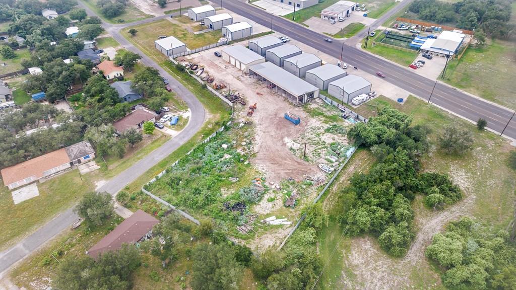 MARKET STREET LOCATION| ALMOST 2 ACRES | OFFICE | TWO RESTROOMS | Situated close to the Bypass and close to Downtown Rockport, This location is great for light industry. An office with lots of storage, your team will be able to have product on hand and ready to go! A large metal building with 3 huge garage doors plus and attached heavy equipment, covered storage barn. If you're looking to tear all this down and improve the land, that's ok to ...you have 1.9 acres to create your next development.  Overhead doors are 14'x14', the equipment barn door openings are 11x14