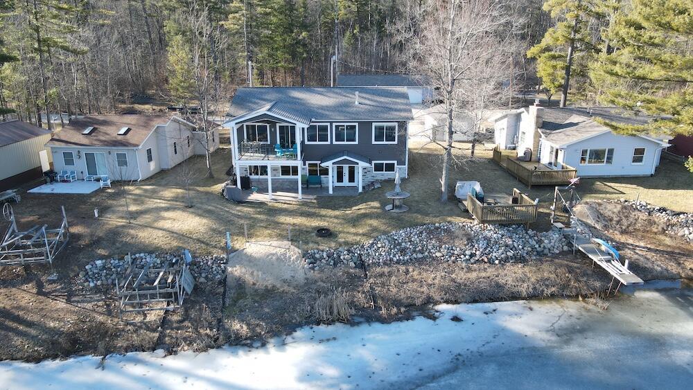 Welcome to this stunning custom-built lakefront home on Secord Lake, built in 2018 with over 2,200 sq. ft. of thoughtfully designed living space. Perfectly crafted for both comfort and style, this home offers 3 bedrooms, 2.5 baths, and a dedicated office, ideal for working from home while at your up north Retreat.Every detail showcases quality craftsmanship, including custom maple accents milled from a large tree on the property and solid slab maple stair treads, lending warmth and character throughout. The spacious living room features a stone gas fireplace, perfect for cozy gatherings, while the gourmet kitchen impresses with stainless steel appliances, ample counter space, and a thoughtful layout for both everyday living and entertaining.Step outside to the second-story covered porch with glass railings, offering breathtaking views of Secord Lake, an ideal spot for morning coffee, evening sunsets, or simply enjoying the peaceful surroundings.The finished walkout lower level is complete with a kitchenette and opens up to your own private lakefront, where you have a beautiful covered patio area and your own beach.  Its the perfect setup for summer fun with friends and family.Modern comforts are built into every corner of the home, including forced air heat with central air conditioning, a built-in humidifier, and a 22kW whole-home generator, ensuring peace of mind year-round.  This home combines quality construction, thoughtful design, and a lifestyle centered on Secord Lake, making it a rare opportunity for luxury lakefront living. An additional 1.2 acre lot across the street is also available, which would be a great place to build an additional garage for even more storage space.Secord Lake is a prime destination for boating, fishing, and making unforgettable summer memories. Whether you're cruising the water, fishing from your private shoreline, or gathering with family and friends, this location offers the ultimate lake lifestyle. Water access is available now, with the lake scheduled to return fully in Se