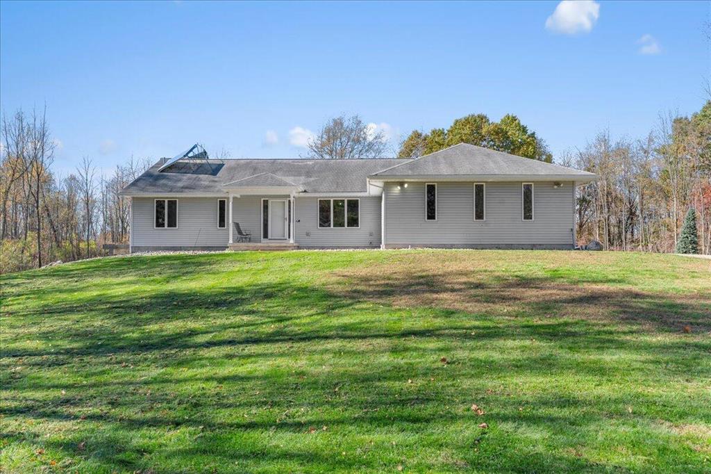 This beautiful, custom-built executive ranch sits atop nine secluded, densely wooded acres, offering exceptional privacy and natural beauty. The home features a spacious main-floor primary suite with an en-suite bath, large walk-in closets, a marble shower, and a relaxing whirlpool tub. An open floor plan with cathedral ceilings enhances the sense of space, while EnergyStar efficiency ensures comfort and performance throughout.  The fully finished walkout lower level provides additional living space with a cozy rec room and fireplace, two generous bedrooms, and a full bath--perfect for guests or family.A true highlight of this property is the impressive nearly 4,000 sq. ft. pole barn. Designed for versatility, it includes two separate heated spaces, two 14' access doors on one side, and a 2.5-car access door on the other. The building is also plumbed for a full bath and offers the potential to include a kitchen--ideal for a workshop, hobby space, or business use.