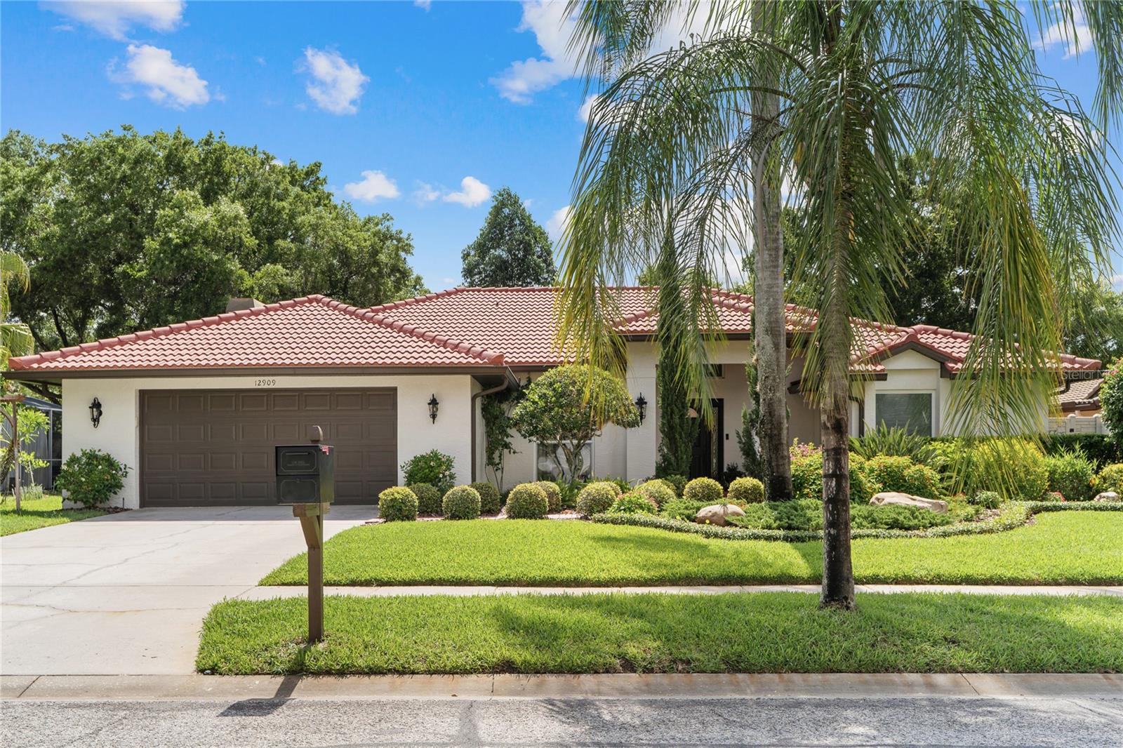 Welcome to your forever home in the highly sought-after Village Wood community. Situated on a private 0.27-acre lot, this exceptional 4-bedroom, 3-bath residence showcases more than $200,000 in high-end upgrades, offering a rare blend of luxury, comfort, and thoughtful design.Inside, you’ll find elegant wood-plank style tile flooring, designer light fixtures and spotlights throughout, cohesive matte black hardware, custom closets, updated doors, baseboards, and trim, along with freshly painted interiors and retextured ceilings and walls. The home is fully integrated with a smart home system controlling lights, locks, pool pump, garage door, thermostat, and sprinkler system.The stunning primary suite features a fully remodeled spa-inspired bathroom with a marble tile shower, floating soaking tub, dual vanities with quartz countertops, and independent his-and-hers shower heads. Both secondary bathrooms have also been completely remodeled with luxurious marble finishes.The chef’s kitchen is a true centerpiece, featuring a brand-new custom design with an oversized island, two pop-up outlets, custom range hood, coffee bar with sink, paneled dishwasher, matching appliances, stovetop, and dual ovens.Additional interior highlights include:Updated fireplace in the living room,Remodeled laundry room with cabinetry and quartz countertops,Garage workshop with custom cabinets, tool storage, and upgraded lighting.Major system upgrades include a new AC system (2023), new ductwork, and added insulation for enhanced comfort and efficiency.Step outside to your beautifully redesigned outdoor retreat featuring:Fresh professional landscaping,Expanded sprinkler system,Pool safety fence,Wood ceiling detail in the lanai,New exterior lighting,Fresh exterior paint,Backyard storage shed.Perfectly located within walking distance to Carrollwood Village Park and Carrollwood Cultural Center, and just one mile from Carrollwood Country Club. Conveniently close to Tampa International Airport, Raymond James Stadium for the Tampa Bay Buccaneers, Spring Training home for the New York Yankees and the year-round home for their Single-A affiliate, the Tampa Tarpons, Benchmark International Arena for the Tampa Bay Lighning, the Veterans Expressway, top-rated schools, International Plaza and Bay Street, Midtown Tampa and Downtown Tampa.This is a rare opportunity to own a meticulously upgraded home in one of Tampa’s most desirable communities.