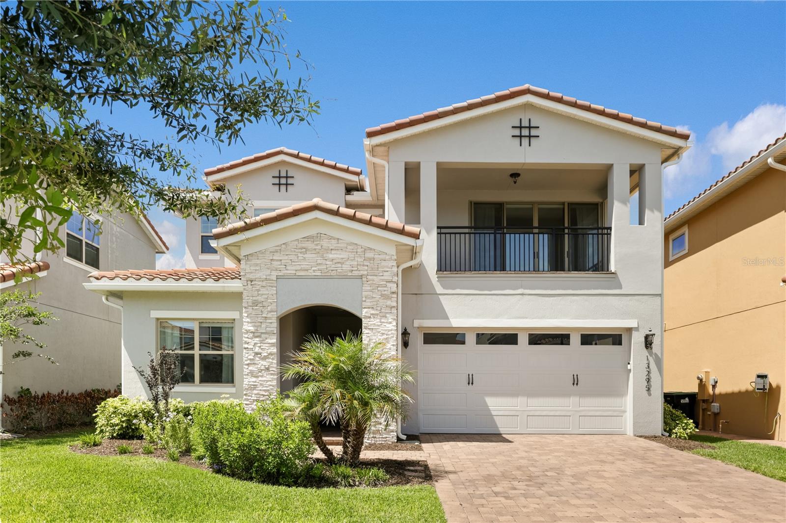 Welcome to luxury living in Eagle Creek—one of Lake Nona’s most sought-after gated golf communities. This stunning 5-bedroom, 5.5-bath residence perfectly blends elegance and everyday comfort with water views, spacious living, and thoughtful design throughout.Step inside to an inviting open floor plan highlighted by natural light, tray ceilings, and designer finishes. The gourmet kitchen features sleek quartz countertops, double ovens, a gas cooktop, walk-in pantry, and a large island that opens to the dining area and great room—ideal for gathering and entertaining. A wall of glass sliders extends the living space to the covered lanai, where you can dine al fresco or relax while overlooking the tranquil water.Upstairs, the expansive primary suite offers serene water views and private access to a covered balcony—the perfect place to enjoy your morning coffee or sunset breeze. The spa-inspired bath features dual vanities, a large glass-enclosed shower with pebble flooring, and a spacious custom closet with built-ins. Every bedroom in the home includes its own ensuite bath, offering privacy and comfort for family and guests alike.The second-floor loft serves as the ultimate hangout, complete with a wet bar and space for a theater setup or game nights. Outside, the fully fenced backyard features premium artificial turf, ideal for low-maintenance play and entertaining year-round.Eagle Creek residents enjoy resort-style amenities including a pool and splash zone, clubhouse with gym and event space, lighted tennis courts, playground, dog park, and multi-use fields. Golf lovers will appreciate the community’s championship course, pro shop, and on-site restaurant—all just steps away. Zoned for top-rated Lake Nona schools and moments from Medical City, shopping, dining, and theme parks, this home delivers family-friendly luxury in one of Orlando’s premier locations.
