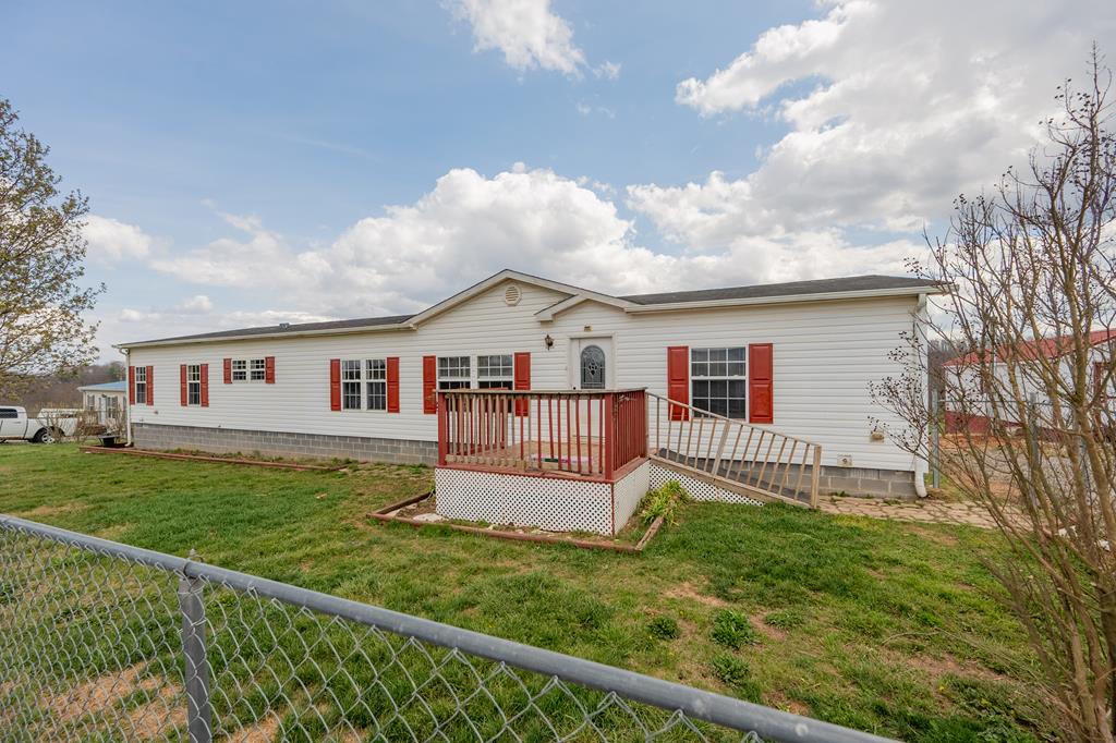 Spacious and inviting, this beautifully maintained 4-bedroom, 2-bath manufactured home offers over 2,200 sq. ft. of finished living space on 1.6 peaceful acres. Inside, you'll love the large open floor plan featuring an upgraded kitchen with stone column accents, perfect for cooking and gathering. A formal living area provides a bright welcoming space, while the cozy den with fireplace creates the ideal spot for relaxing nights at home. The master suite is thoughtfully separated from the additional three bedrooms for added privacy and showcases a stand-up shower, double vanity, and relaxing soaker tub in the master bath. Outside, the chain-link fenced front yard is perfect for pets, and the expansive backyard offers plenty of room for entertaining, play, or future additions. Take in the long-range views from the rear decks—your own private escape at home. A fantastic property with space, comfort, and views—ready for its next owner to enjoy!