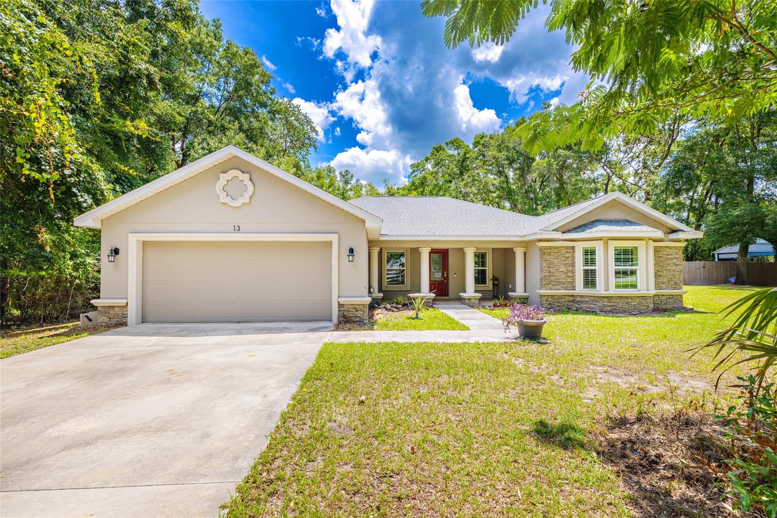 Experience luxury and tranquility in this amazing 2019 custom-built Frank Equi home, offering 2,037 square feet of thoughtfully designed living space. Nestled in the quiet, horse-friendly community of Meadow Wood Farms, this 4-bedroom, 3-bath pool and spa home sits on a private 1.6-acre corner lot surrounded by towering trees—just minutes from the World Equestrian Center (WEC) and HITS.
Enjoy your own outdoor oasis featuring an open-air saltwater pool and spa, a spacious lanai, and a full outdoor kitchen perfect for entertaining. The property boasts beautiful curb appeal with brick accents and a welcoming front porch. Inside, the modern open floor plan includes vaulted ceilings, a cozy propane gas fireplace, and stylish porcelain tile throughout the main areas and carpet in the bedrooms.. The kitchen shines with granite countertops, bar seating, stainless steel appliances, and a generous pantry, all adjacent to a well-sized dining area.
The split bedroom layout offers privacy and functionality. The spacious Primary Suite includes a tray ceiling, cozy carpeting, a seating area, and French doors leading to the lanai. The en-suite bathroom features dual granite vanities, a walk-in shower, and a built-in bench. Three additional bedrooms and two more bathrooms provide a flexible layout ideal for guests or a potential in-law suite. One bedroom is currently used as an office.
Additional highlights include a fenced area of the lot, ample space for equestrian additions, a storage shed, and 2019-installed well and septic systems and the home is a smart home. With a low voluntary HOA fee of only $95/year, no CDD, and SECO Electric, this home offers freedom and comfort in an unbeatable location. Zoned for Romeo Elementary, Dunnellon Middle, and West Port High.
Don't wait—this property is a rare find!