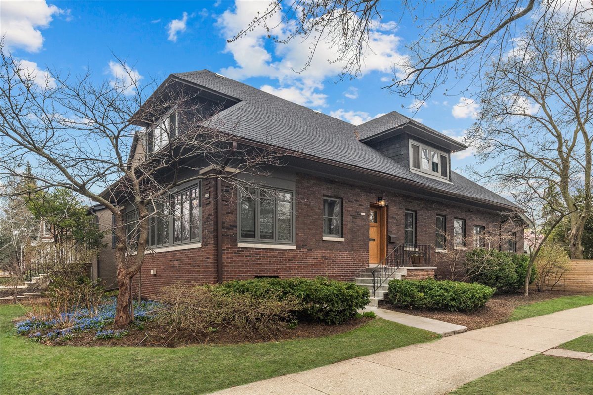 This stunning, recently renovated Chicago Arts & Crafts bungalow is a singular opportunity, nestled on an oversized 50x172 corner lot in the historic West Ridge neighborhood of Rogers Park. With numerous recent updates, this rare gem perfectly fuses classic charm with modern enhancements, leaving nothing to do but enjoy the comfort and elegance it offers, all with unbelievably low taxes. Inside, the main level enchants with vintage details such as beautiful hardwood floors, intricate woodwork, and leaded glass windows. The formal dining room features a beamed ceiling, while the living room, with its decorative Roman brick fireplace and built-in bookcases, leads to a cozy light-filled sunroom. A newly renovated kitchen boasts custom cabinets, stainless steel appliances, a designer backsplash, and honed granite counters with a breakfast bar, seamlessly connecting to the family room and eat-in area, ideal for entertaining. New French doors open to a large new deck, a brick paver patio, and a luxurious hot tub, surrounded by one of the most beautifully landscaped private yards on Chicago's north side. The first floor is completed by a spacious bedroom and fully renovated marble bath. Upstairs, the primary suite boasts a newly added spa-like en suite bath, with separate soaking tub, massive walk-in shower, double vanity, and honed limestone. Two additional bedrooms, all with custom closet shelving, and a newly renovated hall bathroom complete the second floor. The finished lower level offers versatile space with a recreation room, storage, and laundry area, complete with new flooring. The home features a new roof, AC units, and numerous other recent upgrades and updates. Located near Indian Boundary and Warren Parks, this home is a one-of-a-kind opportunity, blending historic charm and modern luxury. Don't miss your chance to own this extraordinary property in one of Chicago's historic neighborhoods.