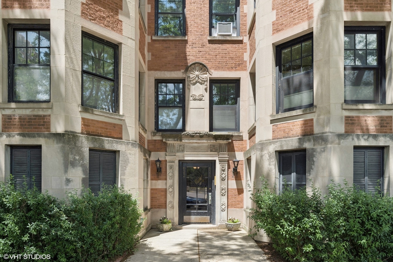 With a sprawling floorplan and the perfect blend of vintage details and modern updates, this 3-bedroom/2-bath residence in a classic pre-war building right off the lakefront is both elegant and practical. A proper entry leads to an enormous living room with a fabulous decorative fireplace flanked by built-in bookshelves (fireplace could be made woodburning). Right off the living room is a glorious sunroom in the trees. A large separate dining room leads to an eat-in white kitchen w/granite counters and stainless appliances - and to a large deck overlooking the lush backyard. The primary suite has an oversized bathroom w/double bowl vanity, separate shower, and jacuzzi tub. Enjoy hardwood floors, high ceilings, in-unit washer/dryer, and an enormous private storage room. Ideal location right off the lake and park, with restaurants, boutiques, Wrigley, and public transportation within steps from your doorstep. Prime deeded garage space at the New York building across the street available separately for $35k.