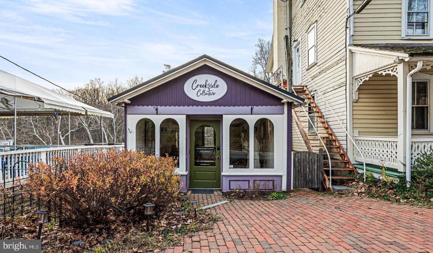 Saint Peters Village itself is a 19th-century industrial village, just ¼ mile in length, where time seems to slow down and history is preserved at every turn. Let your imagination run wild with this truly charming commercial property nestled in the heart of this historic village. Dating back to 1881, this building once served as the carriage house for The Excursion House, known today as the Saint Peters Inn - an enduring piece of local history that now offers endless possibilities for its next chapter.  A series of colorful historic buildings line the village, now home to artisan shops, inviting eateries, a tiny cider bar, and even an old-timey arcade - a setting that truly takes you back in time. Though modest in size, the potential here is anything but. The main level features an open, sun-filled space with beautiful hardwood floors and abundant natural light - ideal for a boutique retail shop, artist studio, gallery, wellness space, or intimate event venue such as baby showers or wedding showers. Downstairs, you’ll find a convenient bathroom, and a small gathering space w/ refrigerator, offering added flexibility for a variety of uses. Step outside and you’re instantly transported. A deck and stairs lead down to French Creek, where the sound of rushing water over ancient boulders politely commands you to slow down and take a deep breath. Beyond the creek, adjoining woods and miles of scenic trails create a rare and peaceful backdrop - an experience that simply can’t be replicated. Additional highlights include a 10-year-young standing seam metal roof, providing durability and peace of mind. Parking is also plentiful, and utilities are quite reasonable. Small but special, rich with history, and surrounded by nature, this is a rare opportunity to own a space where creativity, commerce, and timeless charm intersect in one of Chester County’s most beloved villages.