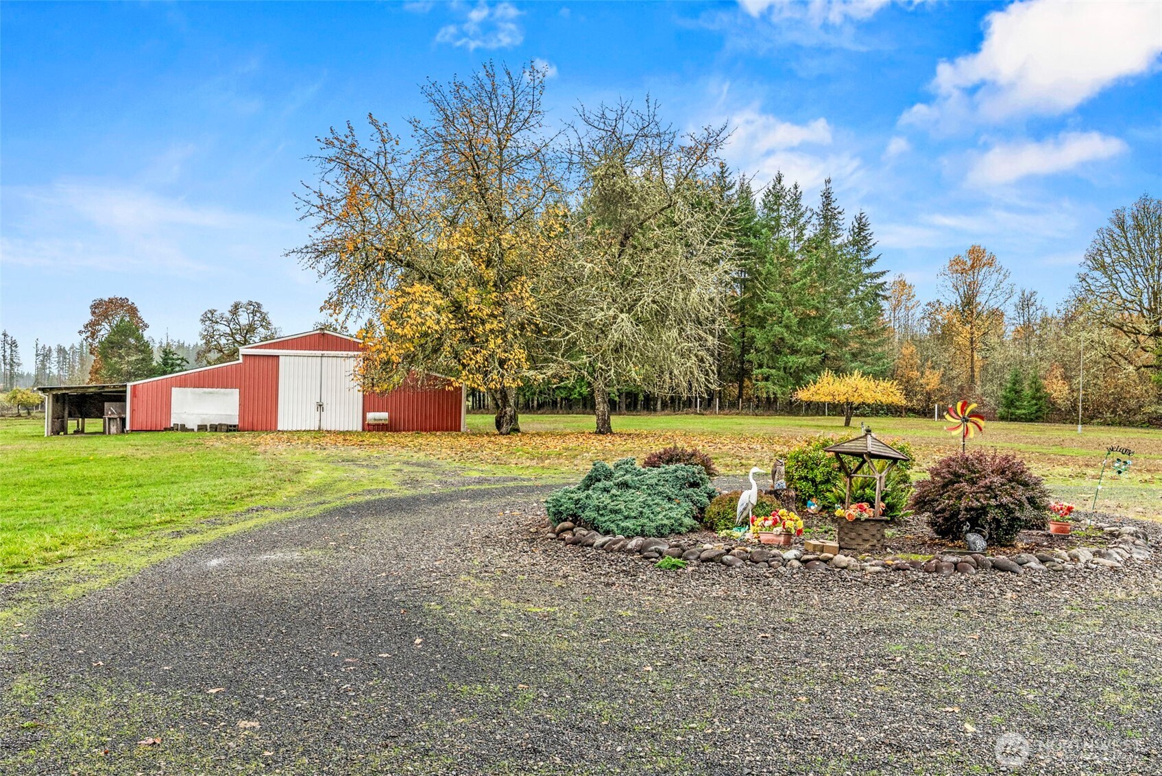 Unlock the potential of this incredible property, featuring almost 20 acres of flat, usable land that borders the serene Lacamas Creek accompanied by a massive 3,000 ft² shop/barn and a charming 1976 single-wide 1232 ft² trailer home, waiting to be transformed into your dream haven. Actual address is 307 Pine Tree Rd but county has address/parcel location as on Henriot Rd.
