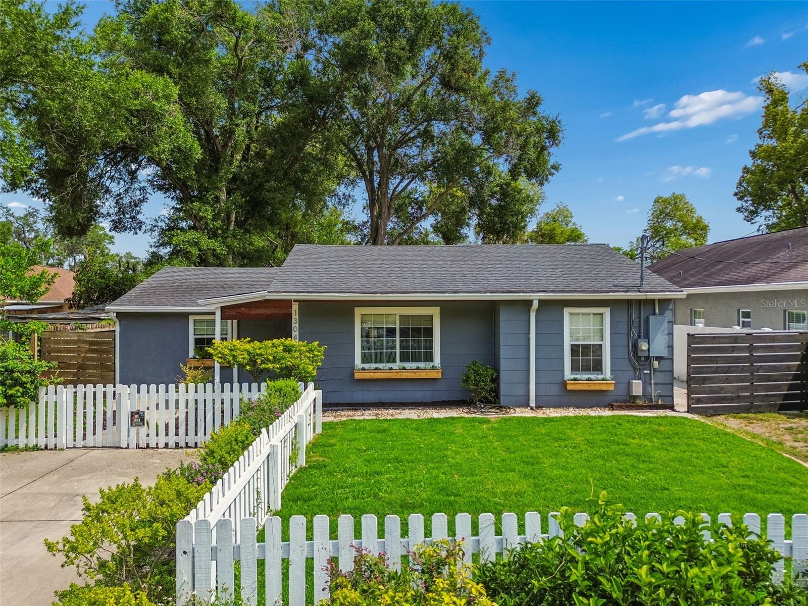 Beautifully updated and move-in ready, this Seminole Heights gem sits on an oversized 58x175 homesite with exceptional indoor and outdoor living space. A recently re-sodded and landscaped fenced front yard creates inviting curb appeal. The expanded parking offers incredible flexibility with a two-car parking pad and an extended original driveway designed to accommodate multiple vehicles, boat, or RV parking.Inside, the thoughtfully designed split floor plan features new interior paint and wood-look stamped tile flooring throughout. The spacious living room flows seamlessly into the fully renovated kitchen, showcasing white shaker cabinetry to the ceiling, quartz countertops, marble backsplash, stainless steel appliances, and additional pantry storage. The private primary suite has been beautifully updated with a remodeled en suite bath featuring a tiled walk-in shower, along with a conveniently located laundry closet. Two additional bedrooms offer built-in closets and including one with custom wood built-ins. One of the standout features is the massive fully screened rear patio, creating an incredible extension of the living space and the perfect setting for year-round entertaining. The fully fenced backyard offers endless possibilities with ample room for a future pool, guest house, storage shed, or backyard reimagining. Major improvements include electrical panel update (2021), full home repipe (2020),  roof (2019),  HVAC (2017), water heater (2017), updated flooring, new paint, remodeled primary bath, and screened patio enhancements. Additional features include a water softener treatment system, insulated windows, attic insulation, and installed pest control bait stations. Ideally located near Seminole Heights favorites, shopping, dining, and quick access to I-275 for an easy commute throughout Tampa.