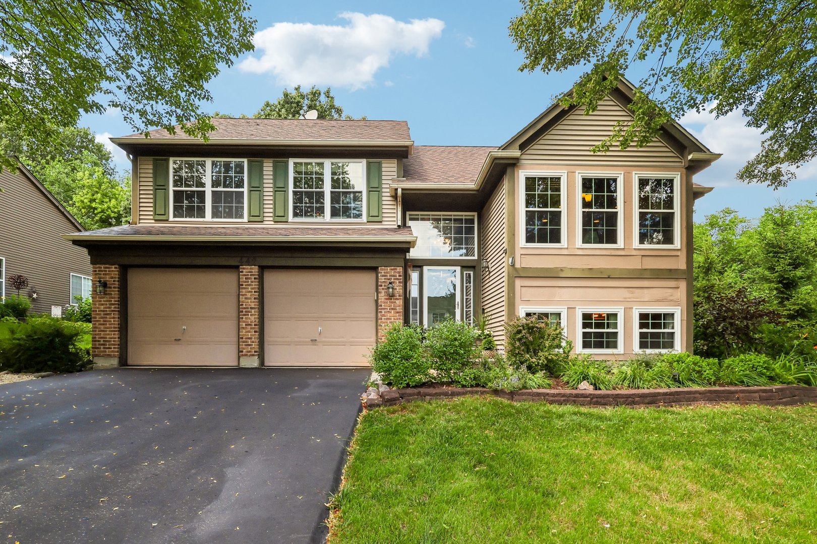 Welcome to 442 Harbor Drive in Carpentersville-where nature, privacy, & relaxation come together to create an extraordinary place to call home.    Tucked away on a quiet cul-de-sac & backing to historic Raceway Woods Forest Preserve, this exceptional 4-bedroom, 3-bath home offers over 3,000 square feet of finished living space designed for both everyday comfort &  effortless entertaining.    Vaulted ceilings, expansive windows, & rich bamboo flooring create a bright, welcoming atmosphere throughout the main living areas. The kitchen flows seamlessly into the living room & out to the covered deck, while the main-level primary suite offers peaceful backyard views, a walk-in closet with a convenient laundry chute, a private ensuite featuring a multi-body spray shower. Two additional bedrooms & a full bath complete the upper level.    The kitchen is equipped with stainless steel appliances, while a heated garage & newer windows add comfort & convenience. The finished lookout lower level provides even more flexible living space with a spacious family room centered around a beautiful stone fireplace, a wet bar, fourth bedroom, full bath, &  a versatile bonus room tucked behind French doors-ideal for a home office, gym, playroom, or hobby space.    But the true showstopper is what awaits outside.    Step outside from the living room onto the raised deck & take in breathtaking views of the backyard that truly sets this home apart. Lovingly designed & handcrafted over the years, this one-of-a-kind outdoor retreat features terraced landscaping, cascading waterfalls, mature trees, a gazebo, fire pit, handcrafted swings, extensive landscape lighting that creates stunning nighttime ambiance, & a private pathway leading directly into Raceway Woods Forest Preserve. Whether you're enjoying your morning coffee while watching wildlife or unwinding to the peaceful sounds of flowing water, every day feels like a private getaway.    Homes offering this unique combination of generous living space, unmatched outdoor beauty, & direct access to nature are exceptionally rare.     Located just minutes from shopping, dining, & the charming downtown of East Dundee, yet feeling worlds away, 442 Harbor Drive offers a lifestyle that is truly unlike any other.  Welcome Home.