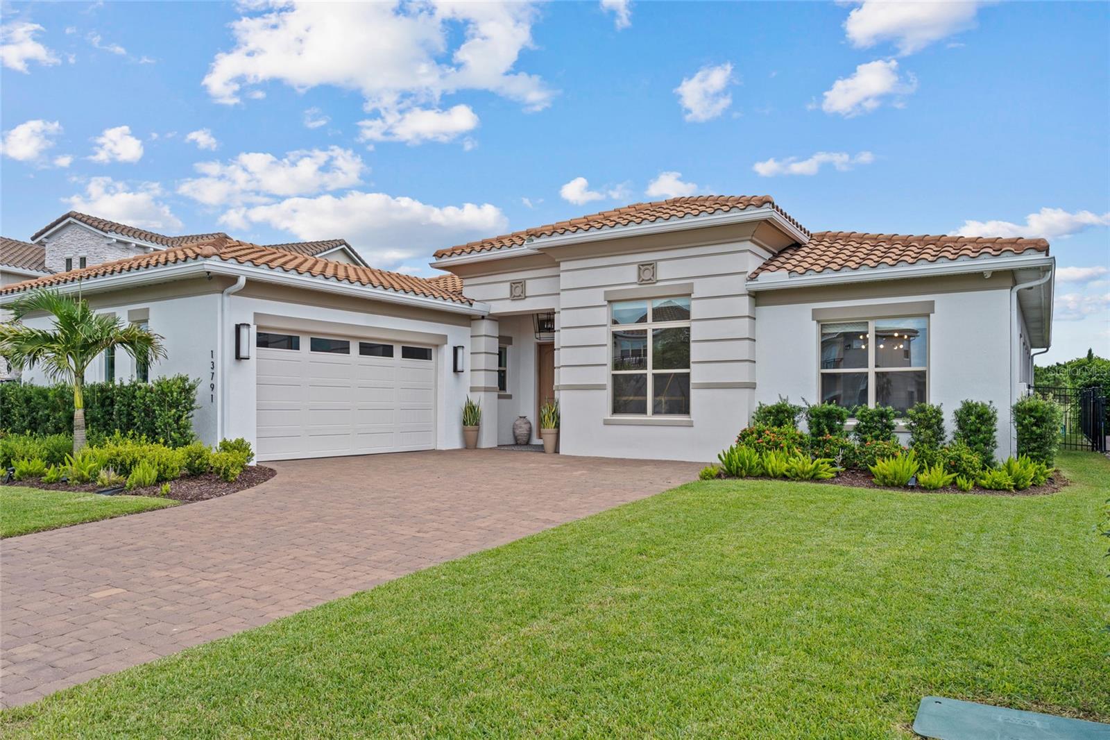 Welcome to luxury living in Eagle Creek—one of Lake Nona’s most sought-after gated golf communities. This stunning 4-bedroom, 4-full bath residence perfectly blends modern and elegance. Experience everyday comfort located on a quiet could-de-sac, tucked away with rear conservation views, spacious living, and generously thoughtful upgrades throughout. Step inside to an inviting open floor plan highlighted by natural light, extended ceilings, and custom finishes. The gourmet kitchen features sleek quartz countertops, built-in oven, glass cook top, oversized walk-in pantry, coffee/dry bar and a large island that opens to the dining area and great room—ideal for gathering and entertaining. A wall of glass sliders extends the living space to the covered lanai (operated by remote control functions), where you can dine or relax while overlooking the peaceful conservatory views with no rear neighbors. Living room is equipped with built-in surround sound speakers. This single story home has 4 bedrooms and 4 full bathrooms. The expansive primary suite offers peaceful conservation views and private access to a covered lanai—the perfect place to enjoy your morning coffee or sunset breeze. The spa-inspired bath features dual vanities, a large glass-enclosed shower with pebble flooring, and a spacious custom walk-in closet with built-ins and a center island. Outside, the fully fenced backyard features mature landscaping ideal for low-maintenance play and entertaining year-round. This home is equipped with a security system and electrical hook-up for tesla charging (charger does not convey). Eagle Creek residents enjoy resort-style amenities including multiple pools and a splash zone, clubhouse with gym equipment and an open space for events, lighted tennis courts, playground(s), dog park(s), and multi-use fields. Golf lovers will appreciate the community’s championship course, pro-shop, and on-site restaurant—all just steps away from your very own front door! Zoned for top-rated Lake Nona schools and moments from Medical City, shopping, dining, and theme parks, this home delivers family-friendly luxury in one of Orlando’s premier locations.