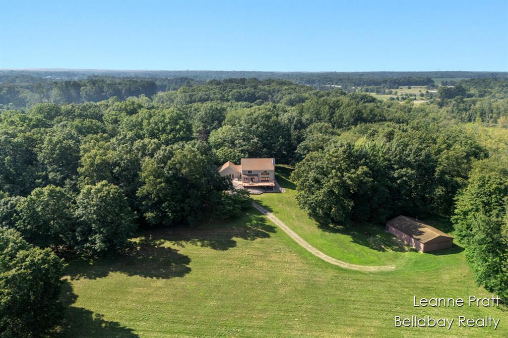 Available to the public for the first time, this majestic timber frame craftsman build overlooks 26.2 acres, which includes tillable, open fields & is surrounded by wooded landscape. BONUS feature includes the Battle Creek River, flowing through the back side of the property, with 1,000+ feet of private frontage. Step inside this craftsman delight & take in the vaulted ceilings, astounding natural daylight and inviting warmth. Featuring a large primary bedroom on the main with ensuite & main floor laundry, single story living offers a life of ease. Travel upstairs to find tranquil loft space & additional bedroom and bathroom. Walkout basement offers impressive workshop, set up for every and any hobby desire! Bonus: large pole barn off back of property for additional storage & work needs!