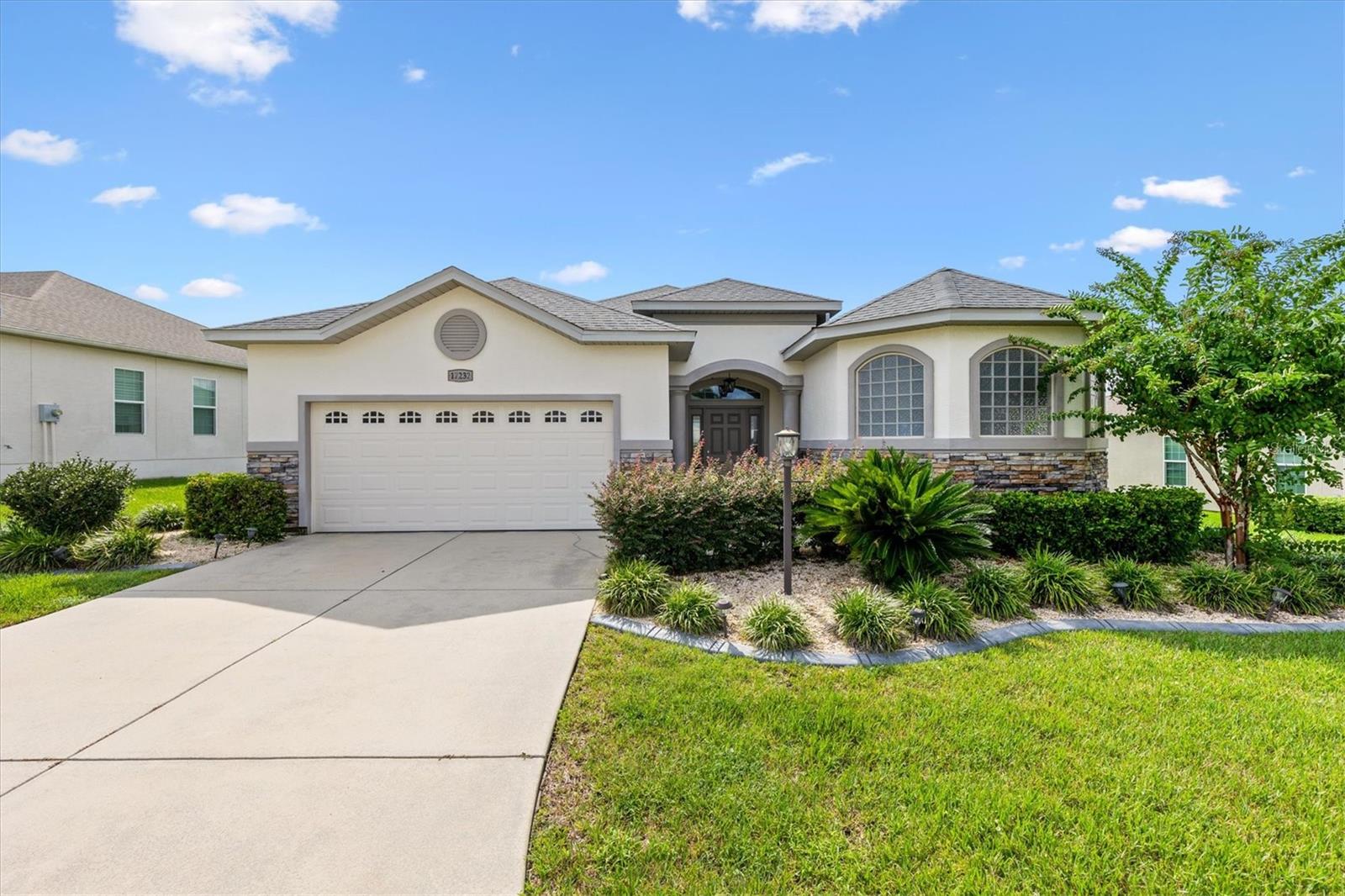 Welcome to paradise in STONECREST, one of Central Florida’s most Desirable 55+ Gated Golf Communities, ideally located adjacent to THE VILLAGES, Florida! Built in 2020, this stunning 3 Bedroom, 2 Bath MAPLE Floor plan offers modern style, an inviting OPEN CONCEPT design, and the perfect setting to enjoy the retirement lifestyle you’ve always dreamed of. From the moment you arrive, you’ll appreciate the attractive stacked-stone façade and professionally landscaped grounds that create wonderful curb appeal.  Step inside and discover a light, welcoming interior Featuring beautiful LAMINATE Flooring throughout the main living areas, comfortable Carpeting in the bedrooms, and TILE in baths and laundry room.  CROWN MOLDING throughout. Elegant multi-horizontal panel interior doors add a touch of elegance throughout the home.  The well-appointed Kitchen Features Stacked Cabinetry, soft close Drawers, gorgeous QUARTZ countertops, and STAINLESS STEEL appliances, combining style and functionality for everyday living and effortless entertaining. The desirable split bedroom floor plan provides added privacy for you and your guests, while the screened lanai offers a relaxing place to enjoy your morning coffee or unwind at the end of the day.  Living in Stonecrest means embracing a lifestyle where every day can feel like a vacation! Enjoy an incredible variety of amenities, including indoor and outdoor swimming pools, a spa, fitness facilities, tennis, pickleball, bocce ball, softball, and a dog park. With more than 80 clubs and social groups, there are endless opportunities to discover new interests, stay active, make lasting friendships, and enjoy an exciting calendar of community activities.  The convenient golf-cart-friendly location makes it easy to enjoy nearby shopping, grocery stores, restaurants, medical offices, and everyday conveniences without always needing to get in your car. Plus, with the shopping, dining, entertainment, and recreation of The Villages just next door, you’ll have even more opportunities to enjoy the very best of Florida living.  Stonecrest offers the freedom to make every day your own. This is more than a home, it’s your opportunity to enjoy the lifestyle you deserve! (Furniture negotiable.)