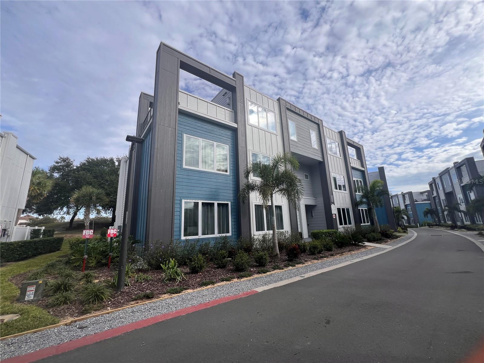 Huge price reduction, lowest priced 5 bedroom in entire community. Why buy new and pay over 100K more! This is just like new, hardly used condo. Sold Fully Furnished! Golf Course Views! Luxury 2 story modern condo in an elevator building with semi-private elevator foyer. This is a 5 bedroom unit! features double height ceilings above living room, One floor accessible with the elevator, you will find 3 bedrooms 2.5 bathrooms, kitchen and living room, there are interior stairs that take you to the top floor with 2 bedrooms 2 bathrooms. Rooftop deck with outdoor furniture. Best location in Spectrum, close to parking lot, pool, clubhouse and gym. No rental restrictions, can rent right away. Investors, this unit is rent ready for you, no need to wait for unit to be furnished and decorated. Membership to Reunion Resort is available for access to the 3 PGA golf courses, mini golf, tennis and Pickle ball courts, restaurants and 5 acre waterpark. Approximately 10 miles from Disney Parks. Community is guard gated, great place to live and to vacation!
