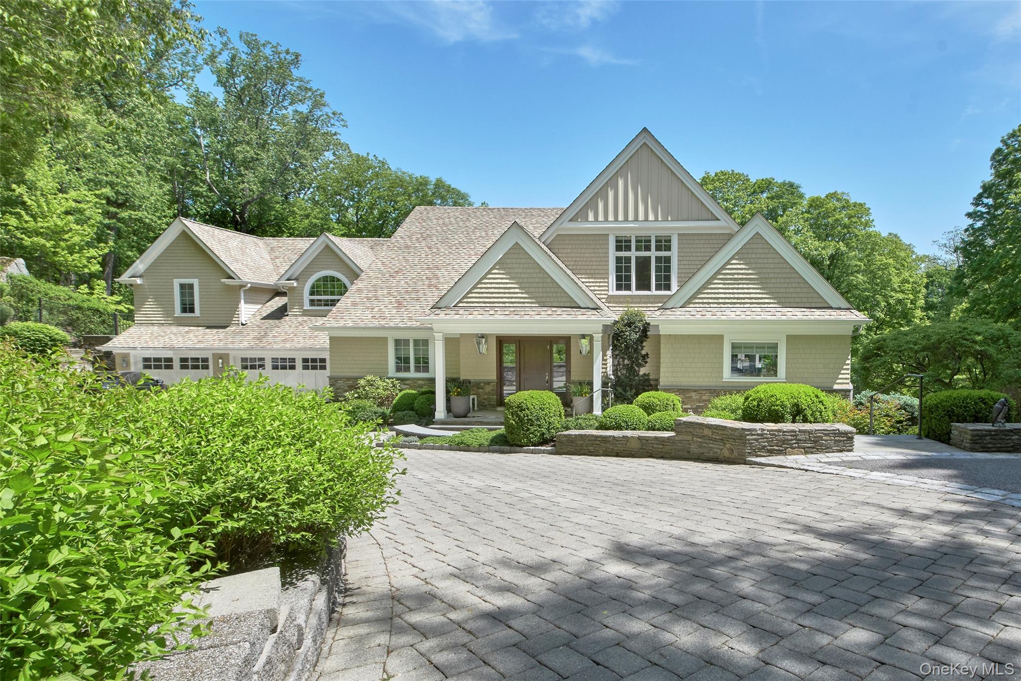 Exceptional and sophisticated Nantucket shingle style Colonial on 3.66 private acres in one of Chappaqua’s most desirable neighborhoods, offers the perfect balance of casual elegance and resort-style living. Just 45 minutes from NYC and minutes to town, train, and top-rated schools, this turnkey home offers unmatched convenience and luxury. Designed for both everyday comfort and effortless entertaining, the property features sophisticated interiors and breathtaking outdoor spaces—creating a true sanctuary for modern family living. From the moment you arrive, you’ll be captivated by the lush, professionally landscaped grounds and impeccable curb appeal. The backyard is a true resort-style retreat, complete with a sparkling pool and spa, a built-in fire pit, an outdoor refrigerator and beverage area, and expansive level lawns—perfect for entertaining or unwinding in total privacy. Step inside and experience a turnkey masterpiece of design and craftsmanship. The interiors are adorned with high-end finishes, custom millwork, gorgeous hardwood floors and designer touches throughout. The chef’s kitchen is an entertainer’s dream, featuring top-of-the-line Wolf ovens and microwave, a six-burner Wolf range, a separate full size Sub-Zero refrigerator and freezer, dual dishwashers, and sleek, custom cabinetry. Other first floor highlights include a large office, a family room w/walls of windows, a billiard or living room w/ bar and sleek built-ins, and an incredible oversized screened porch w/fireplace and TV—perfect for gatherings and seamless indoor-outdoor entertaining. Upstairs, the primary suite is a luxurious sanctuary, boasting exposed wood beams, a cozy stone fireplace, a spa-like ensuite bath w/ steam shower, and generous walk-in closets. Three additional oversized bedrooms—two sharing a bath and one with its own ensuite—offer ample space and comfort, all connected by a versatile upstairs lounge area perfect for homework or hanging out. The finished walkout lower level adds even more living space with a media/playroom, a state-of-the-art home gym, a full bath, and access to a covered porch. Additional premium features include a heated three-car garage, whole-house generator, dual laundry rooms, whole house camera security system, and stunning stone walls that frame the property’s exceptional landscaping. Meticulously maintained and 100% move-in ready, this one-of-a-kind estate is a rare opportunity to enjoy resort-caliber living in a premier location. Prepare to fall in love!
