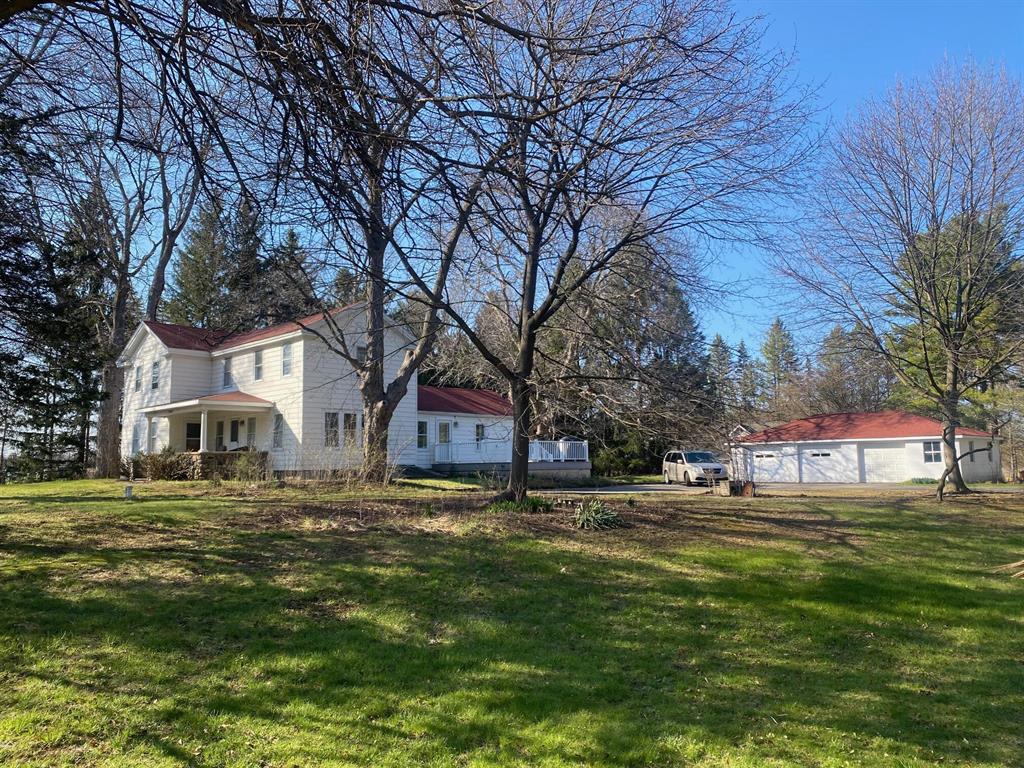 Charming 4-bed, 2-bath historic farmhouse on 1.02 acres in Lima Township, offering classic character, inviting living spaces, and a peaceful AG-1 rural setting just minutes from Chelsea and I-94. The home blends period details with a warm, functional layout that supports comfortable everyday living.A separate commercial building located directly behind the home at 13920 E Old US-12 is also available for purchase for an additional $749,000. 13920 E Old US Hwy 12, Chelsea, MI 48118 GMAR Listing 26014502. Building is currently operated as a licensed daycare under a Special Use Permit and provides opportunities for care-based, professional, or other low-impact service uses. The two parcels may be purchased individually or together as a combined package. Shared driveway has existed for more than approximately 30 years. Seller is currently recording a legal easement to formalize access for both parcels. Easement will be completed and recorded prior to seller accepting any purchase agreeme