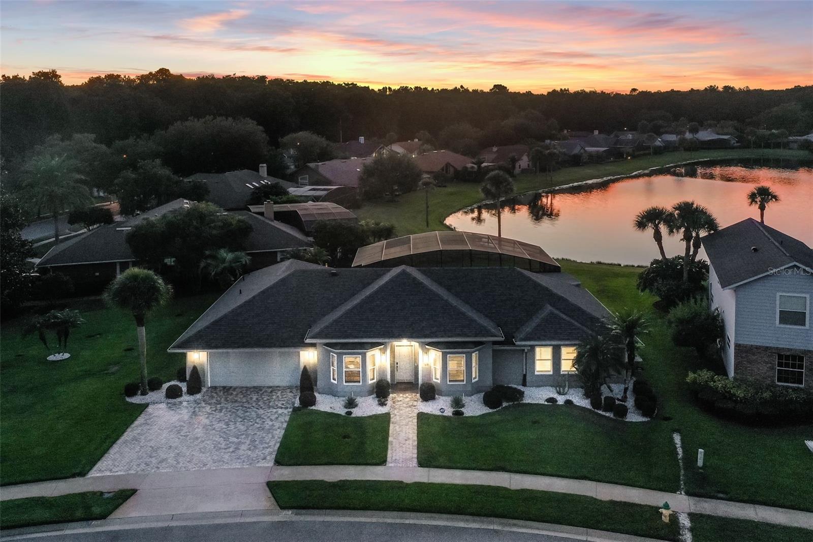 BUYER COULDN'T PERFORM!! Stunning Custom Renovated Pool Home on Oversized Corner Lot in desirable Silver Lakes East. This beautifully upgraded 4-bedroom, 2-bath home sits on an oversized 1/3-acre corner lot with a picturesque view of a retention pond and fountain. Surrounded by lush, manicured landscaping, the property features 10-zone underground irrigation, paver driveway and walkway, and a fiberglass entry door that sets the tone for the elegance within. Inside, you’ll find 8’ and 10’ ceilings, real hardwood floors, porcelain tile in the bathrooms and laundry, and solid wood doors throughout. The home was completely custom renovated in 2020, including a new roof, full interior and exterior paint, plantation shutters on all windows, and automated shades on the sliding doors. Thoughtful upgrades include no-threshold flooring transitions, solid wood cabinetry, Cambria quartz countertops with backsplash, upgraded fixtures, under-cabinet lighting, and high-hat ceiling lighting. The gourmet kitchen is outfitted with top-of-the-line appliances including a built-in GE Monogram refrigerator, oven, glass cooktop, microwave, and wine cooler, plus a Bosch dishwasher and stainless-steel range hood. Bathrooms have been fully modernized, with the owner’s suite featuring an expanded walk-in shower, heated ceiling fixture, stainless grab rails, and a professionally organized walk-in closet. The outdoor living area is equally impressive: the pool and patio were completely renovated in 2023 and include a 50’ x 15’ insulated covered lanai with dual Hunter ceiling fans, a sparkling 19’ x 36’ pool with new equipment, all marble patio deck, screened enclosure, and electric heater with saltwater conversion ready to go. The pool bath is finished with custom cabinetry and a built-in blind within the glass door. Additional highlights include: a GENERAC standby whole-house generator with propane tank, all new tinted exterior windows and sliders, in-floor electrical receptacles, custom laundry cabinetry, Carrier variable-speed A/C with new ductwork and full spray foam attic insulation, and an ADT security system with 4 cameras. This home combines timeless craftsmanship with modern luxury, energy efficiency, and peace of mind—perfect for refined living and entertaining.  All this and more with unbeatable proximity to great schools, world-class attractions, shopping, dining, and bustling business districts, as well as major highways.  This property may be under audio/visual surveillance.