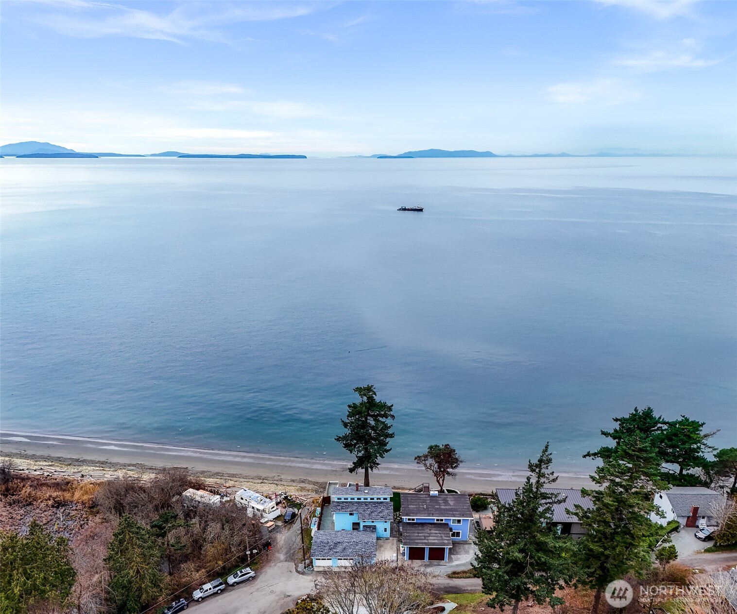 Welcome to the Hamptons of the West -- 4877 Maple Ln Waterfront home perched on a mid-bluff setting. This property is considered the Hamptons of PNW! W/ a fresh seawall & patio area you can enjoy Sunsets all year long. The interior layout features a large living area, dining space, & kitchen. This floorplan offers entertaining space for gatherings w/ large windows for natural light. Upstairs are the bedrooms with plenty of space with 2 bedrooms offering you the magnificent views w/ private decks. With convenient access to parks, local shops, and mins away from Bham. This location combines tranquility with everyday convenience. A rare opportunity to embrace waterfront living in a peaceful Ferndale setting, offering a unique blend of comfort, scenery, and coastal charm.
