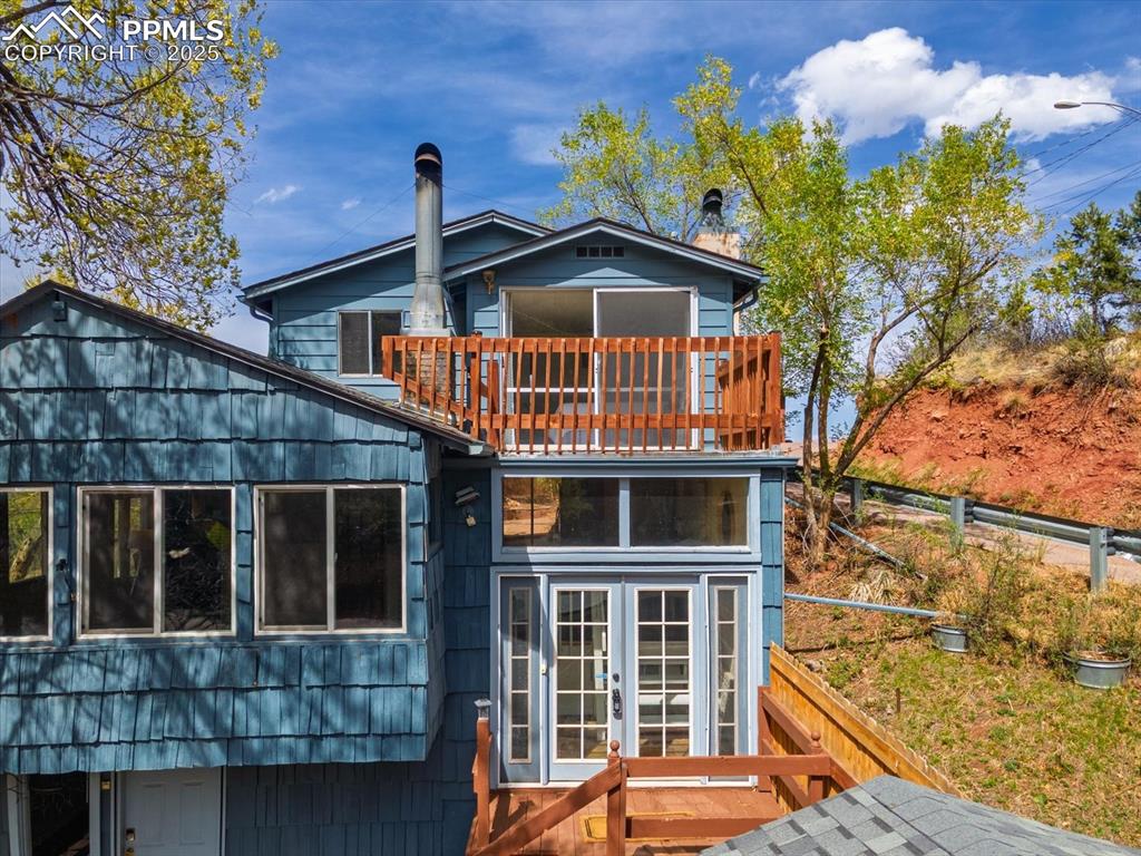Mountain Views, Income Potential, and a Private Backyard Oasis in Manitou Springs. This one-of-a-kind Manitou Springs home offers both charm and versatility. The lower unit provides an opportunity for an income producing rental or guest suite, or you may convert the home back into a large single family home. Inside the upper unit, the home features a bright and cozy sunroom perfect for morning coffee or peaceful afternoon reading. The main living area flows into a well-appointed kitchen with updated cabinetry and fixtures and plenty of counter space. The two upstairs bedrooms boast natural light and views of the surrounding trees and mountains. Step out onto the private deck off the master and take in the fresh mountain air. Out back you’ll find a secluded, fully fenced yard surrounded by mature trees—perfect for outdoor gatherings, gardening, or simply relaxing under the stars. The oversized and recently built two-car garage gives extra room for your gear, tools, or workshop space. The large driveway with plenty of parking is a rare find for Manitou. Located walking distance from historic downtown Manitou Springs, this home gives you easy access to trails, shops, dining, and all that Manitou Springs has to offer—while still offering quiet, private living on a low traffic street. Whether you're looking for a home with income potential or just want to settle into a unique mountain retreat, this home is worth a closer look.