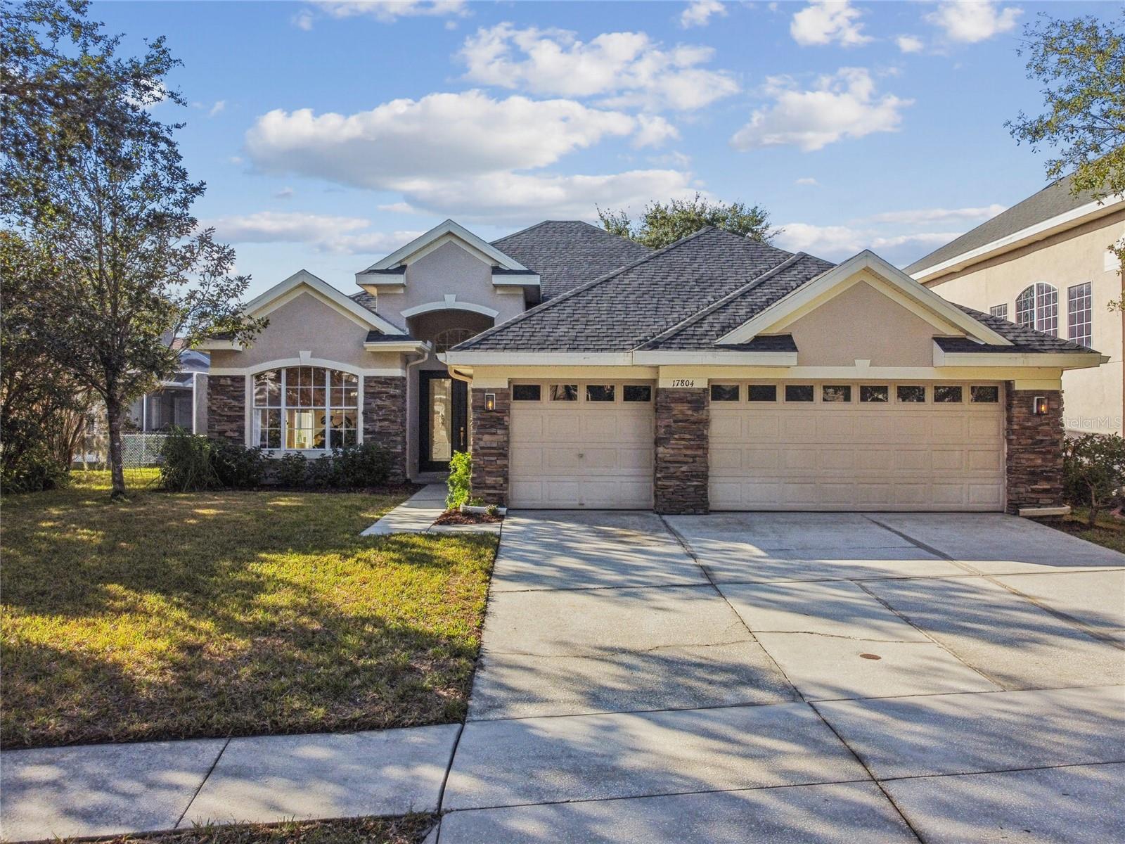 Located in the master-planned community of ARBOR GREENE in New Tampa, this FULLY UPDATED POOL HOME is set on a CONSERVATION AND POND view lot. Offering 3 BEDROOMS PLUS AN OVERSIZED OFFICE OR FLEX SPACE, the floor plan allows for easy conversion to a true 4th bedroom while maintaining an open, light-filled layout with excellent flow for everyday living and entertaining. A newly painted front door welcomes you into a bright interior featuring formal living and dining rooms at the front of the home with abundant natural light. LUXURY VINYL PLANK FLOORING installed in 2024 runs throughout the home with the exception of the primary bath and is complemented by FRESH INTERIOR PAINT, UPDATED LIGHT FIXTURES AND CEILING FANS, AND NEW BASEBOARDS added in 2025. NEW ROOF-2024. The completely REMODELED KITCHEN opens to the great room and screened patio, creating a seamless indoor-outdoor connection with tranquil pond views. The kitchen features TAJ MAHAL QUARTZITE countertops, a large L-shaped double WATERFALL ISLAND with eat-in seating, and customizable cabinetry. High-end appointments include a 48-INCH AGA FREESTANDING INDUCTION RANGE with five elements and triple ovens, updated appliances, an oversized workstation sink, touchless fixtures, instant hot and cold water, reverse osmosis filtration supplying both the sink and refrigerator, and a quiet high-capacity garbage disposal. The private primary suite is tucked quietly at the back of the home and includes double-door entry, backyard views, a REMODELED ENSUITE BATH, and a spacious walk-in closet. Two additional bedrooms are generously sized and feature custom closet systems. The secondary bathroom has been updated with modern finishes, including a microcement and Venetian plaster shower, a thermostatic rainfall shower system, touchless faucets, a tankless bidet toilet with remote, and washable wallpaper treated for water and stain resistance. Additional improvements include surround sound in the living room, primary suite, and patio; a whole-house salt-free water conditioning and filtration system; smart switches, dimmers, thermostat, and irrigation; a smart electrical panel in the laundry room; a laundry room pre-plumbed for a utility sink; and washer and dryer conveying. Living in Arbor Greene offers 24-hour manned gates, resort-style pools, a fitness center, tennis and pickleball courts, playgrounds, and scenic, tree-lined walking paths. Conveniently located near I-75 and I-275, the community provides easy access to Moffitt Cancer Center, USF, AdventHealth, the VA Hospital, Wiregrass, Tampa Premium Outlets, New Tampa and Wesley Chapel dining and shopping, and top-rated schools, making this home ideally positioned within one of New Tampa’s most established gated communities.