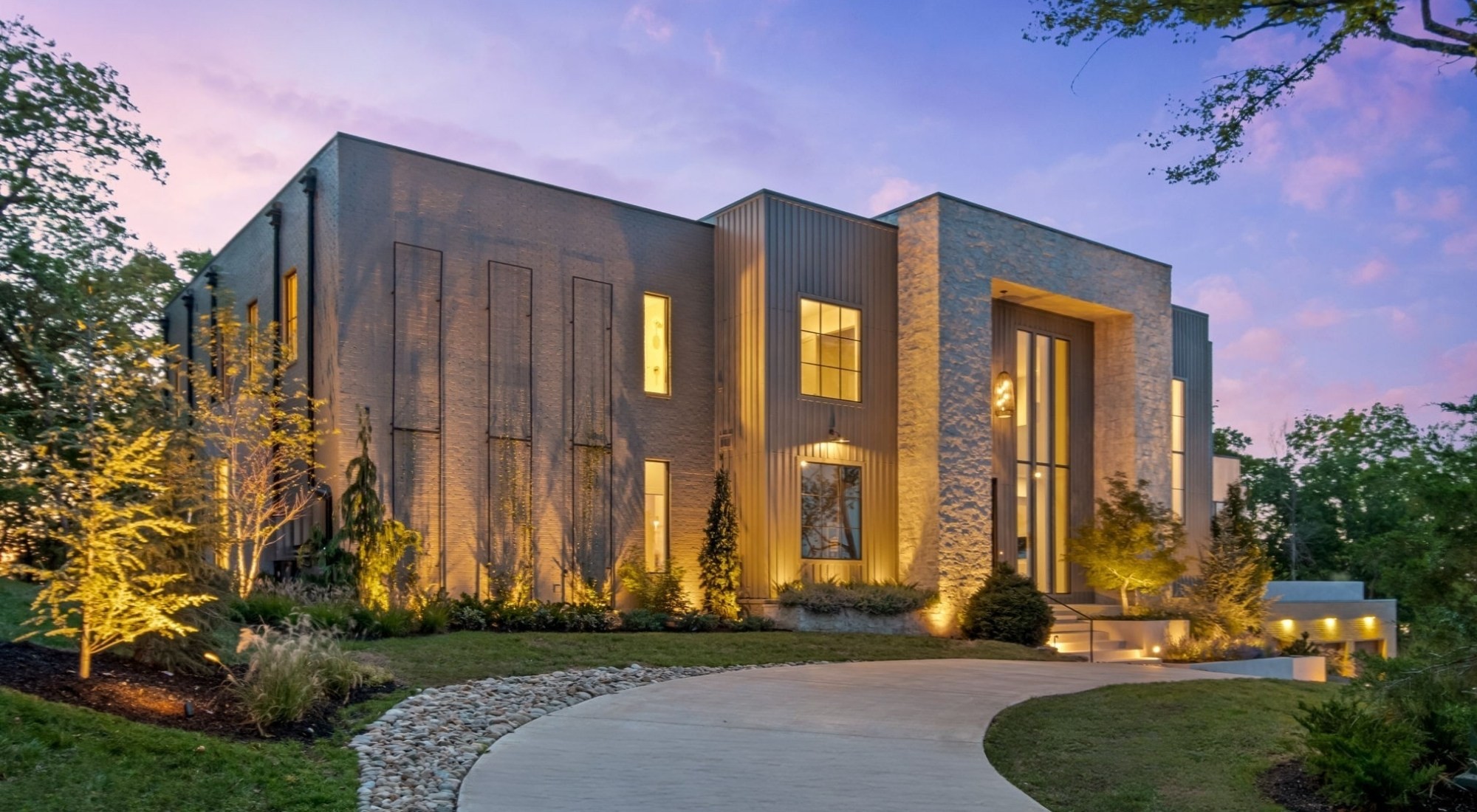 A Majestic New Construction Modern Estate with unrivaled downtown views in Green Hills. Perched atop one of Nashville’s most prestigious enclaves, this gated warm contemporary estate spans 9,700+ sq ft of curated luxury and refined design. Set on 2+ acres of private, manicured grounds, it showcases panoramic downtown vistas. Designed by Millworks, the home blends bold modern form with enduring craftsmanship.

A grand two-story foyer filled with natural light opens to soaring 12’ ceilings and a dramatic great room anchored by a sculptural fireplace and sweeping views. Perfect for sophisticated entertaining, the home features a formal dining room, bespoke bar lounge, scullery, and designer kitchen centered around a striking Taj Mahal quartzite island with custom cabinetry. Every surface, from ArcusStone detailing to designer lighting, was selected to elevate form and function.

The main-level primary suite is a private sanctuary with dual walk-in dressing rooms (pass-through laundry), spa-inspired bath with radiant heated floors, and an ethanol fireplace overlooking the pool.

Upstairs, four en-suite bedrooms, a second laundry, and versatile living spaces provide comfort for family and guests. The fully finished lower level offers a private theater, sixth bedroom, kitchenette, dry sauna, and flex space for gym, studio, or game room.

Step outside to a resort-style oasis with covered/open terraces, a saltwater gunite pool with turf surround, alfresco kitchen, fireplace, and built-in whole-home speakers.

Additional amenities include a 3-car garage with epoxy floors & EV charging, secured entry, smart wiring (Cat 5 & Lutron-ready), 2 tankless water heaters, 4-zone HVAC, drop zone, elevator-ready shaft, and abundant storage.

A rare offering embodying modern sophistication, privacy, and effortless livability, all minutes from Nashville’s best.