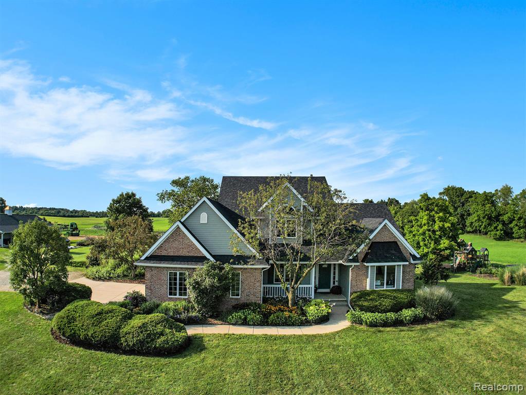 Welcome to your dream retreat! Nestled on 40 breathtaking acres, including 26 acres of premium horse hay, this custom-built 1 1/2 story home offers luxury, comfort, and endless possibilities for hobby farmers, equestrians, or those seeking serene country living. Step inside to discover an open-concept layout and a soaring ceiling in the firelit great room, filling the space with natural light. The island kitchen is a cook’s delight, featuring newer appliances, ample counter space, hardwood floors, and a seamless flow into the main living areas, perfect for entertaining. The first-floor primary suite is a private oasis, complete with a spa-like jetted tub. A separate dining room provides an elegant space for gatherings, while the four-season sunroom invites you to enjoy panoramic views year-round. You'll also love the convenience of first-floor laundry. Upstairs, 2 bedrooms and a full bath can accommodate family or guests, while the walkout basement, already stubbed for a full bathroom, offers even more potential for customization, whether as a rec room, additional bedrooms, or an in-law suite. Step outside to your two-tiered deck, ideal for relaxing or hosting under the stars. Equestrian enthusiasts will appreciate the well-equipped horse barn, complete with water, electric, and numerous upgrades to suit your needs.  The 4" well has a double reservoir and is less than 5 years old. This one-of-a-kind property blends luxury living with agricultural opportunity, just waiting for you to make it your own.