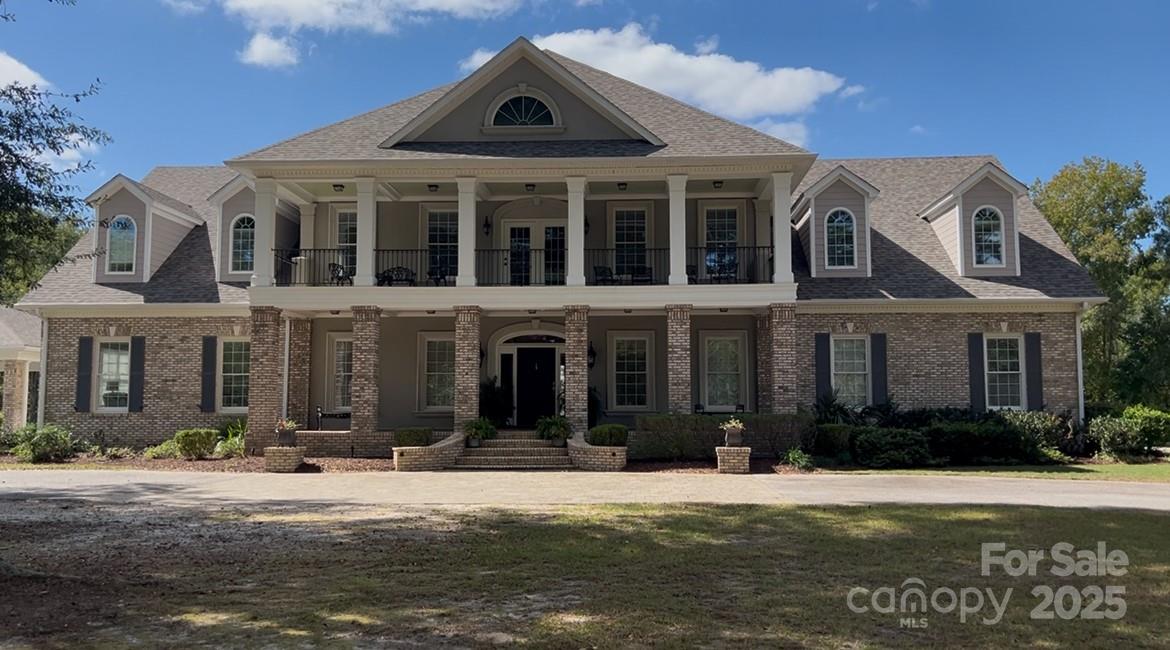 Discover an uncompromising level of Southern luxury in this extraordinary 10,000+ sq ft estate set on 10 peaceful and private acres in Kershaw, ideally positioned between the historic charm of Camden and the convenience of Lancaster. A beautifully designed circle drive—finished with elegant pavers at the entrance—guides you past the stately port-cochère and into this distinguished residence, accompanied by three complementary structures: an all-brick workshop, a classic barn, and a charming outbuilding.
Inside, sophistication unfolds across expansive living spaces, where refined craftsmanship and timeless architectural details create an atmosphere of quiet grandeur. The home boasts three full kitchens in the main house and multiple laundry rooms, offering unmatched convenience and versatility for hosting, multigenerational living, or everyday ease. Three distinct wings provide exceptional flexibility for guests, private offices, or creative spaces, while a private in-law suite features its own garage and separate entrance for added independence and comfort.
The primary suite is a sanctuary of its own, complete with a private library and luxurious his-and-hers bathrooms, each thoughtfully designed for ultimate comfort and indulgence. The dramatic foyer, framed by soaring ceilings, features a light lift providing effortless access to the chandelier—a refined touch perfectly suited to an estate of this caliber.
Outdoor living takes center stage. A sparkling, heated by gas and chlorinated pool is complemented by an impressive pool house offering a full kitchen, full bath, wood-burning fireplace, and outdoor shower, creating a resort-style oasis ideal for year-round enjoyment. Beneath the pool house, a pull-through garage adds both convenience and functionality. Multiple screened-in porches invite seamless indoor-outdoor living throughout the seasons.
This remarkable property features 8 bedrooms, 9 full bathrooms, and 2 half baths ensuring ample space for family, guests, and hosting in complete comfort. The home is further enhanced by numerous recent upgrades, including a new roof (2025), six HVAC units (two from 2020, one from 2021, one from 2022, one from 2025, and the pool house unit from 2009), and five water heaters—three tankless units from 2020 and two 40-gallon electric water heaters from 2009.
Please note: the property’s well pump is not currently operational.
A rare offering of privacy, craftsmanship, and timeless Southern elegance, this estate is more than a home—it is a lifestyle, a retreat, and a legacy.